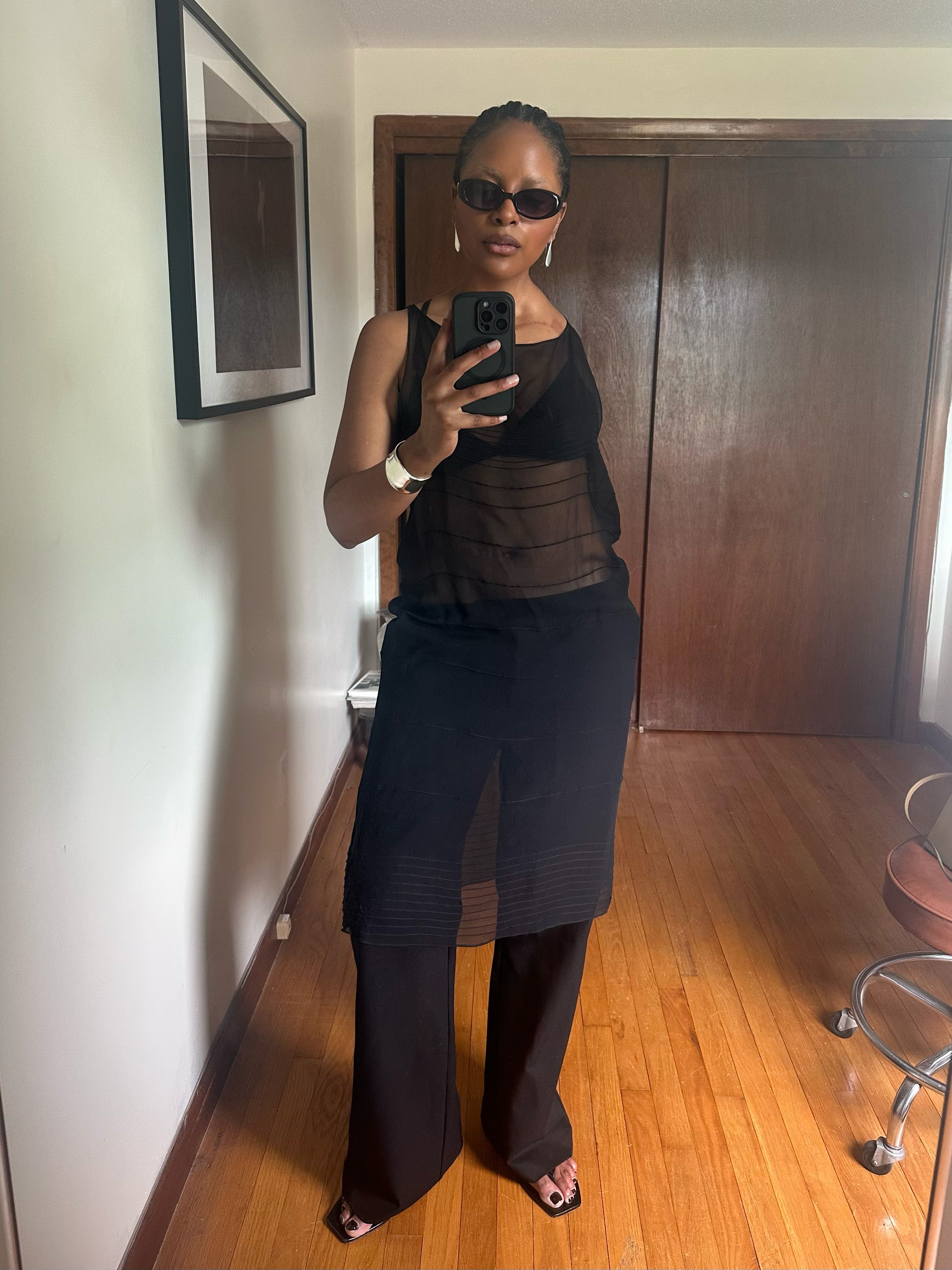 Maya Moore pairs a sheer black dress with low rise pants