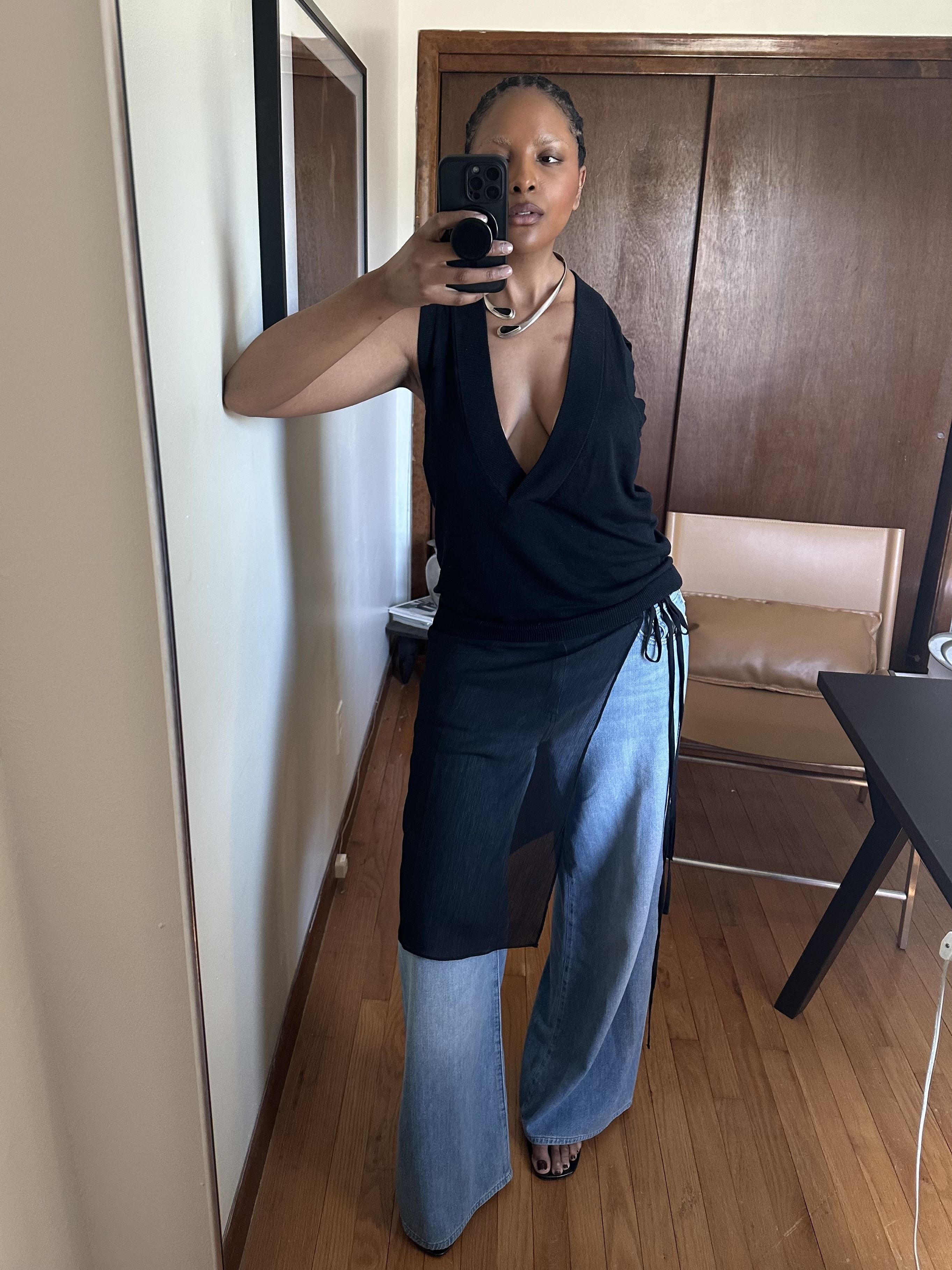 wears a black apron skirt over jeansMaya Moore