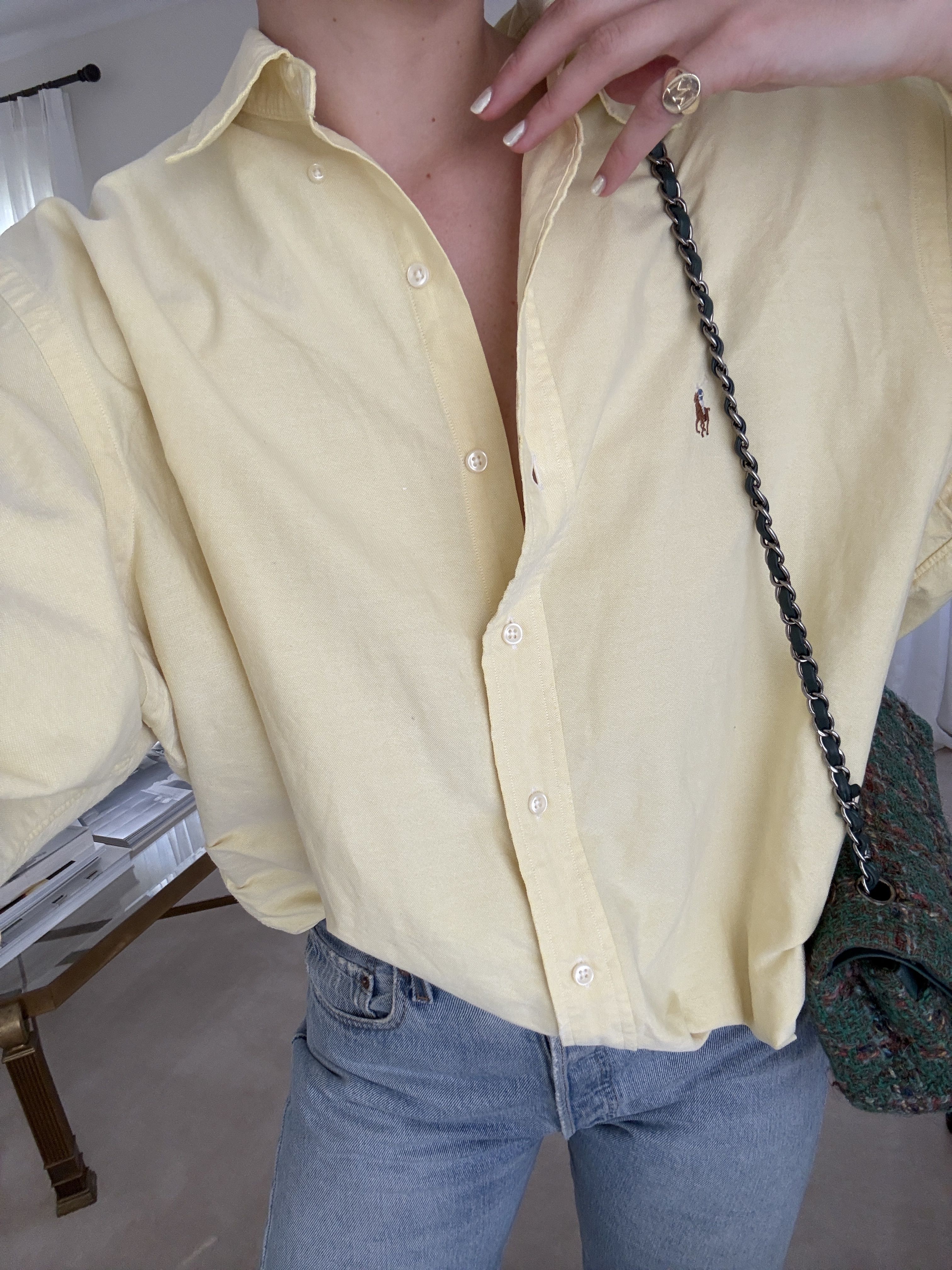 Christie Tyler wears a Polo Ralph Lauren butter yellow button down with jeans and a tweed flap shoulder bag