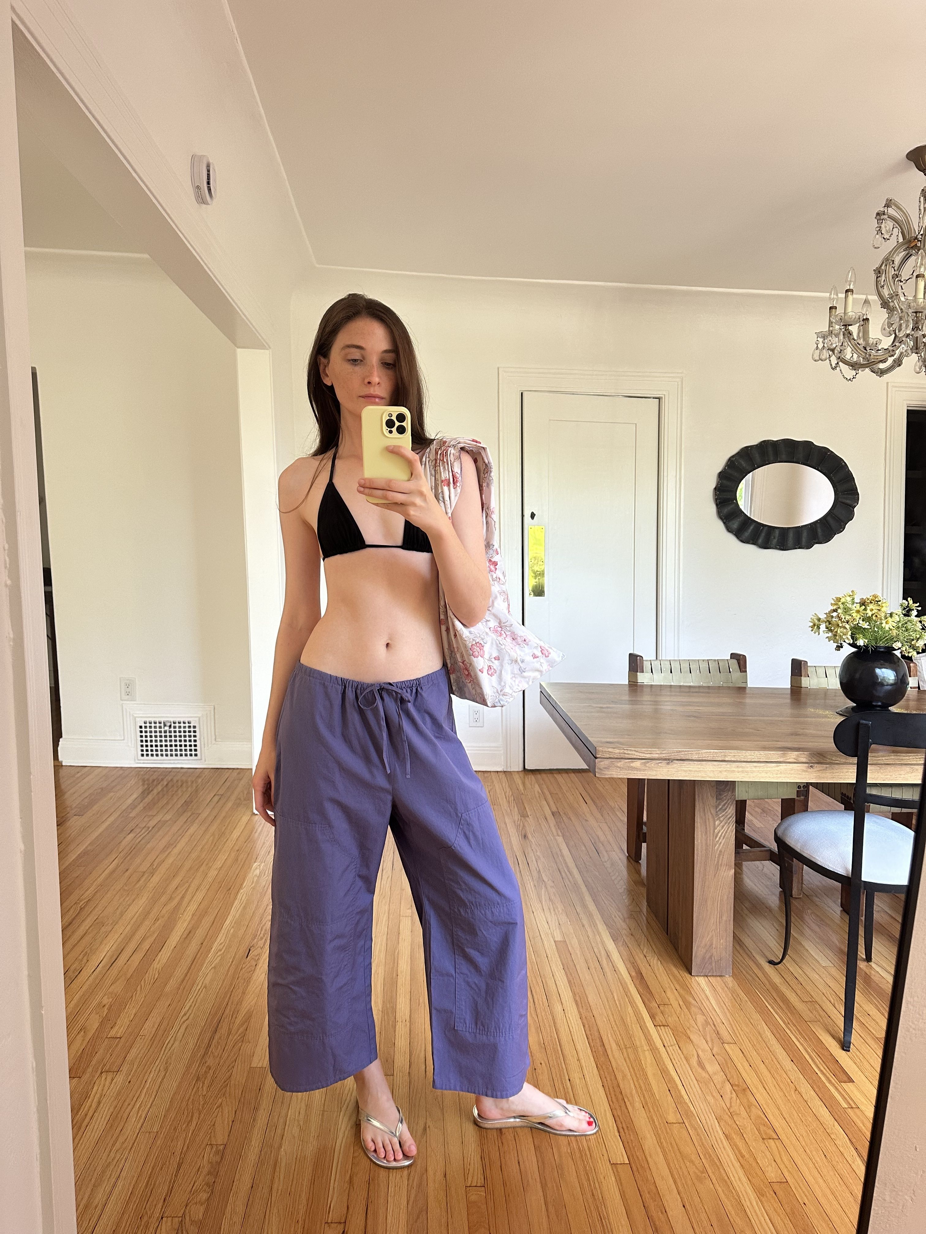Grace O'Neill Dougherty wears colorful pants with a bikini top and flip-flops