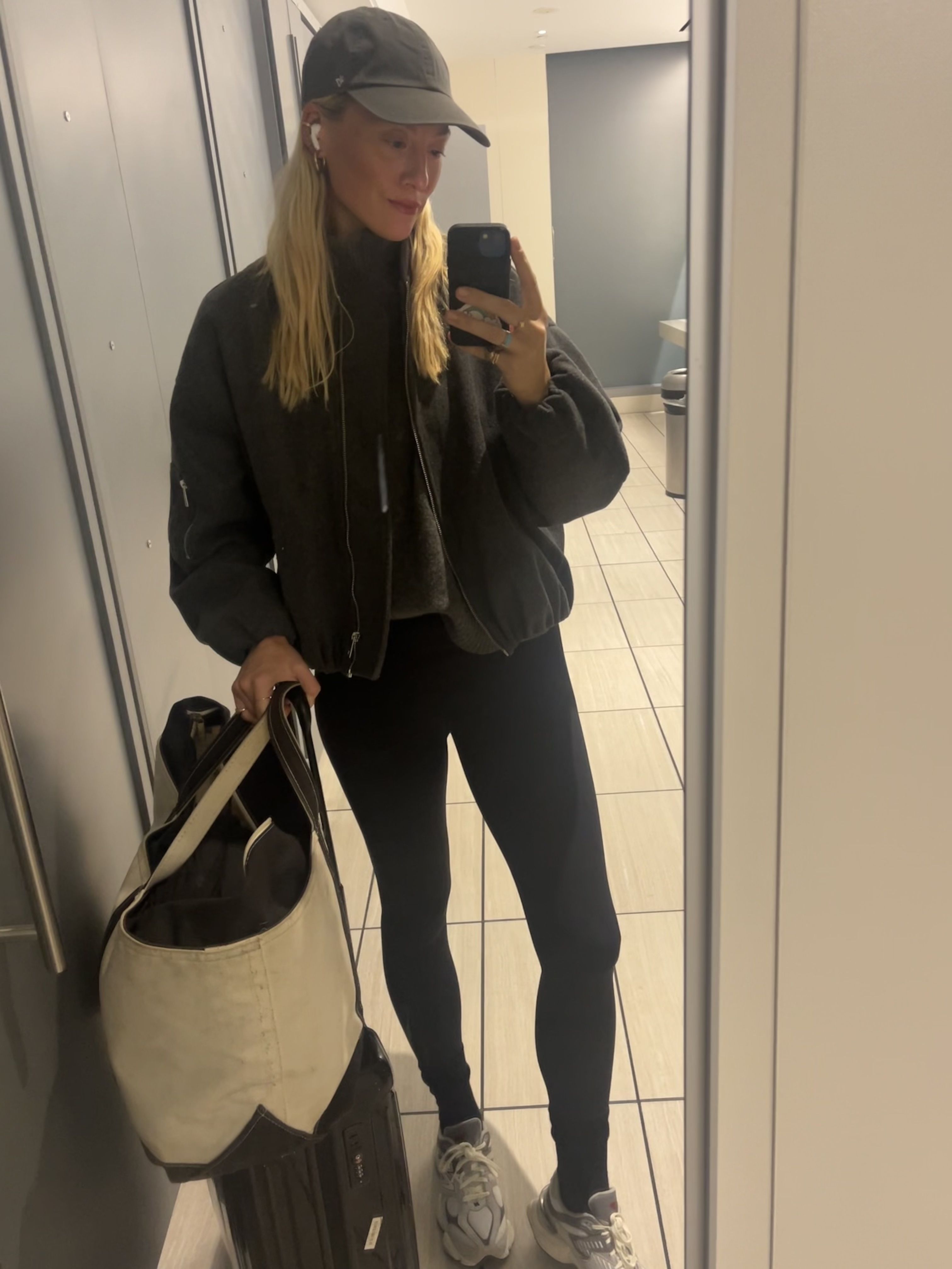 Brooke Ely Danielson holding a suitcase alongside her boat and tote