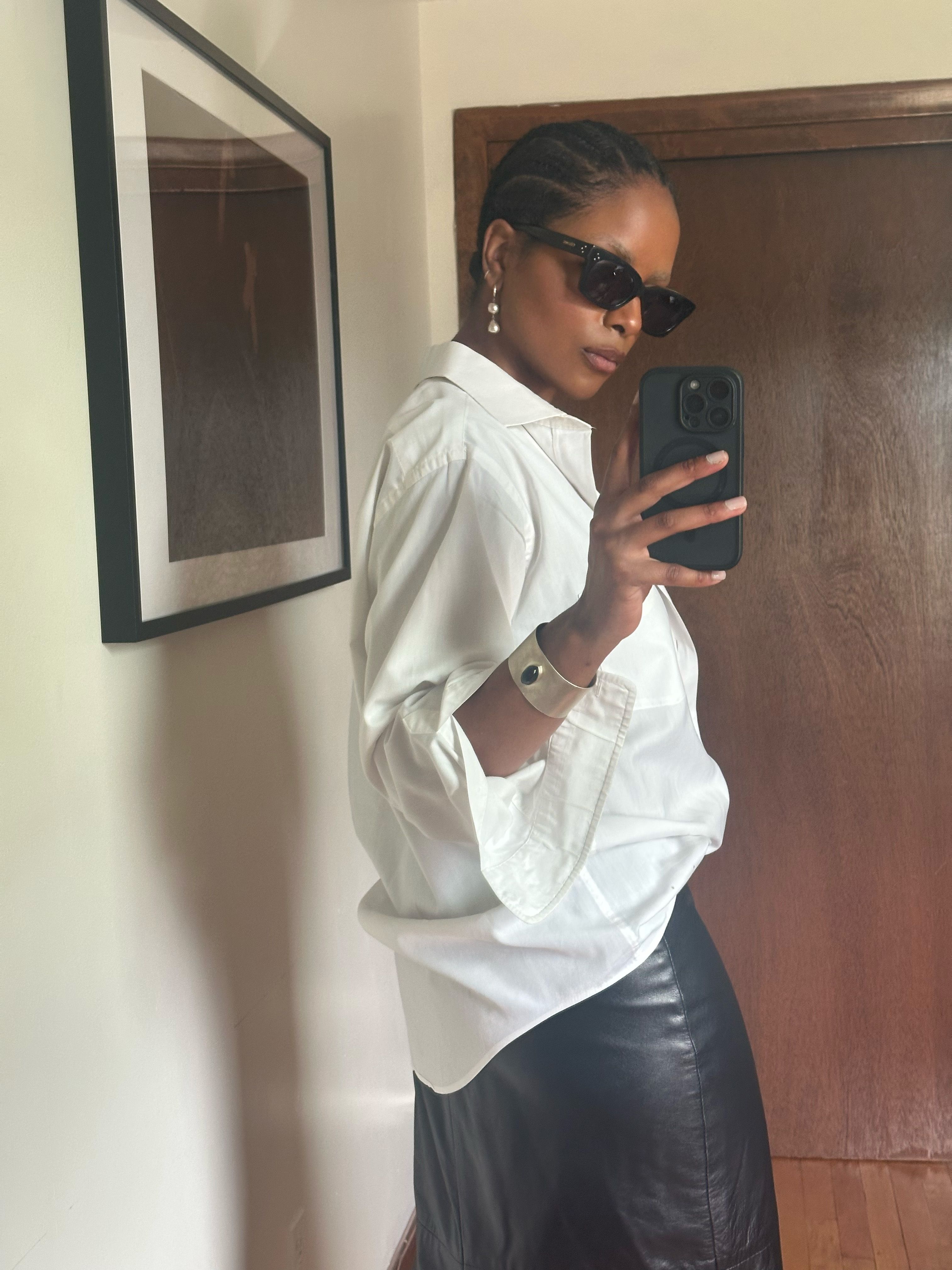 Maya Moore wearing a white shirt and black skirt