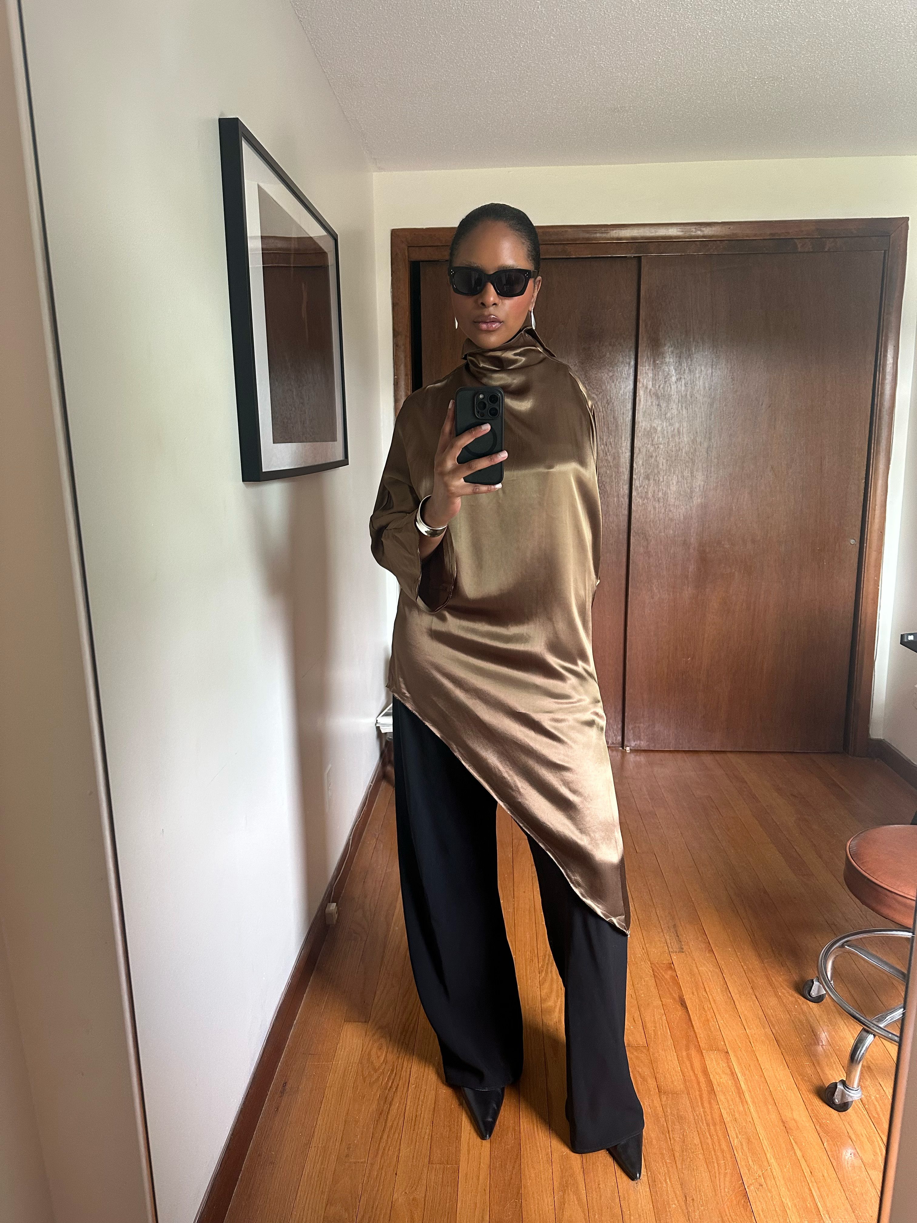 Maya Moore wearing a gold dress over black trousers