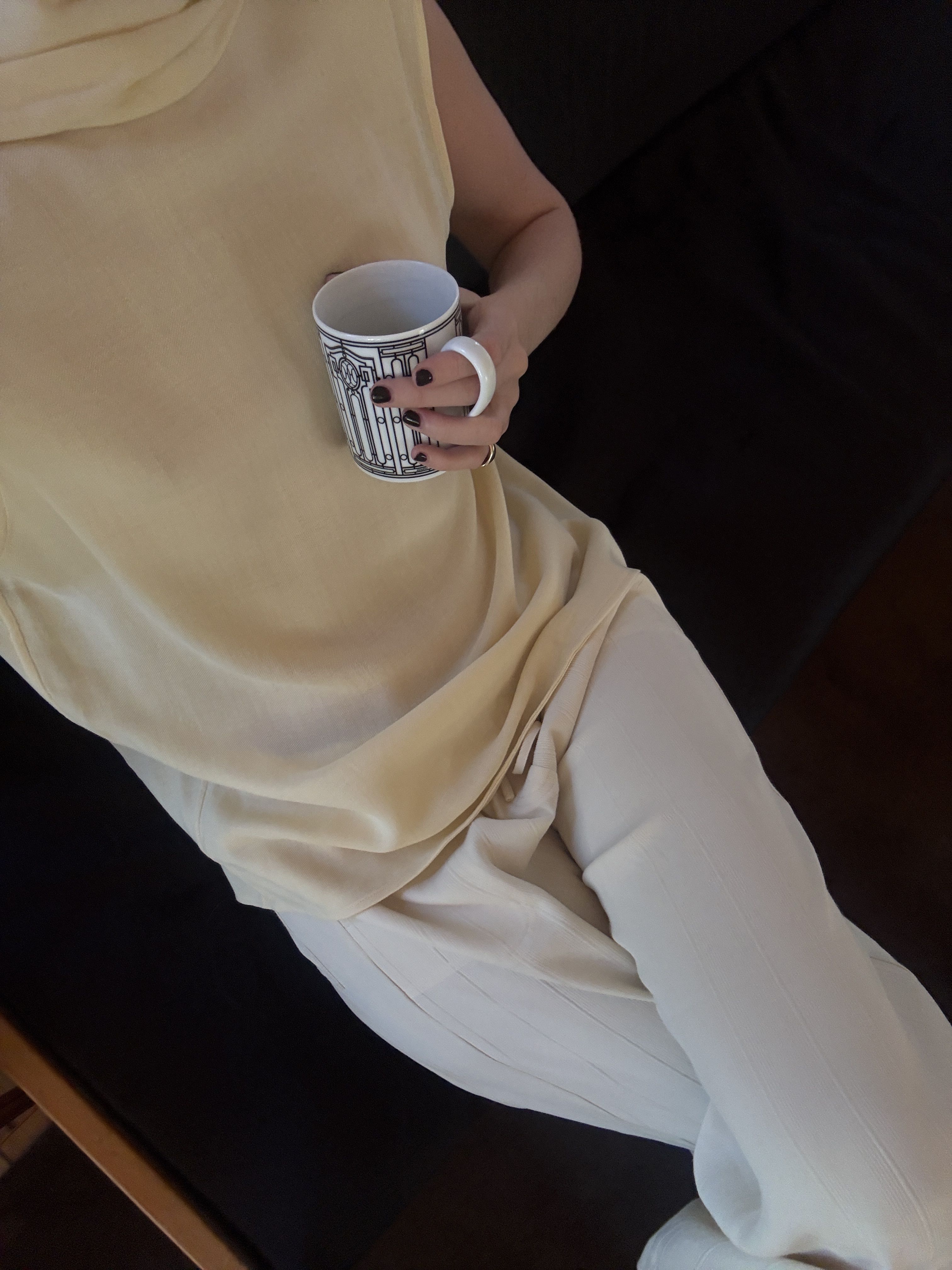 Christie Tyler wears a sleeveless butter yellow top with light-colored pants