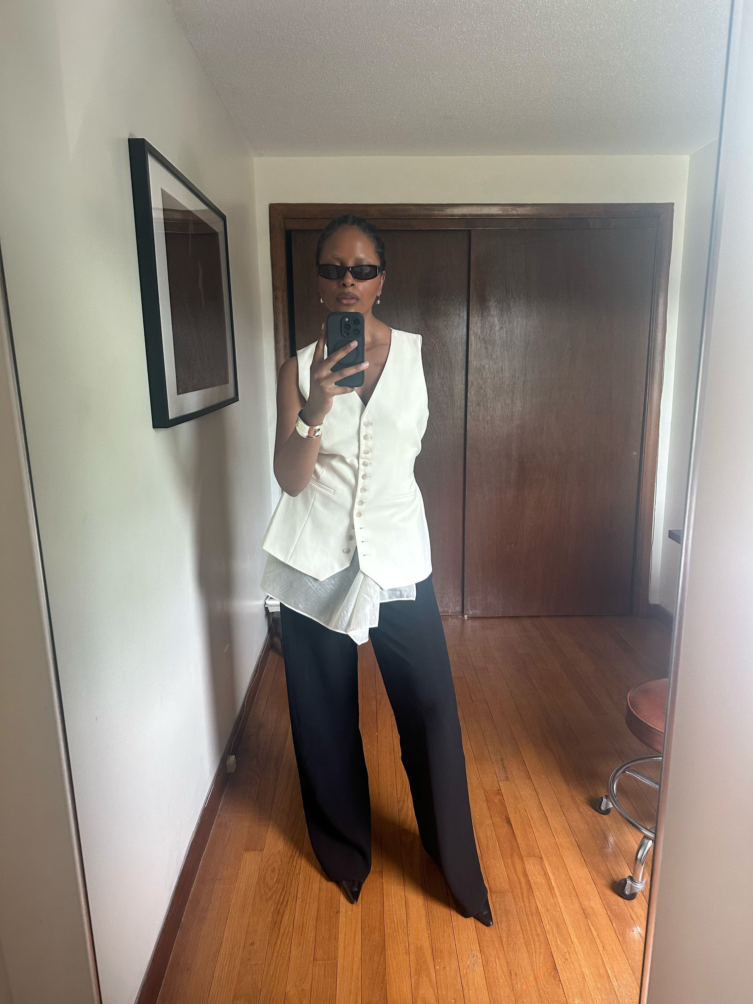 Maya Moore wearing a white top and black trousers