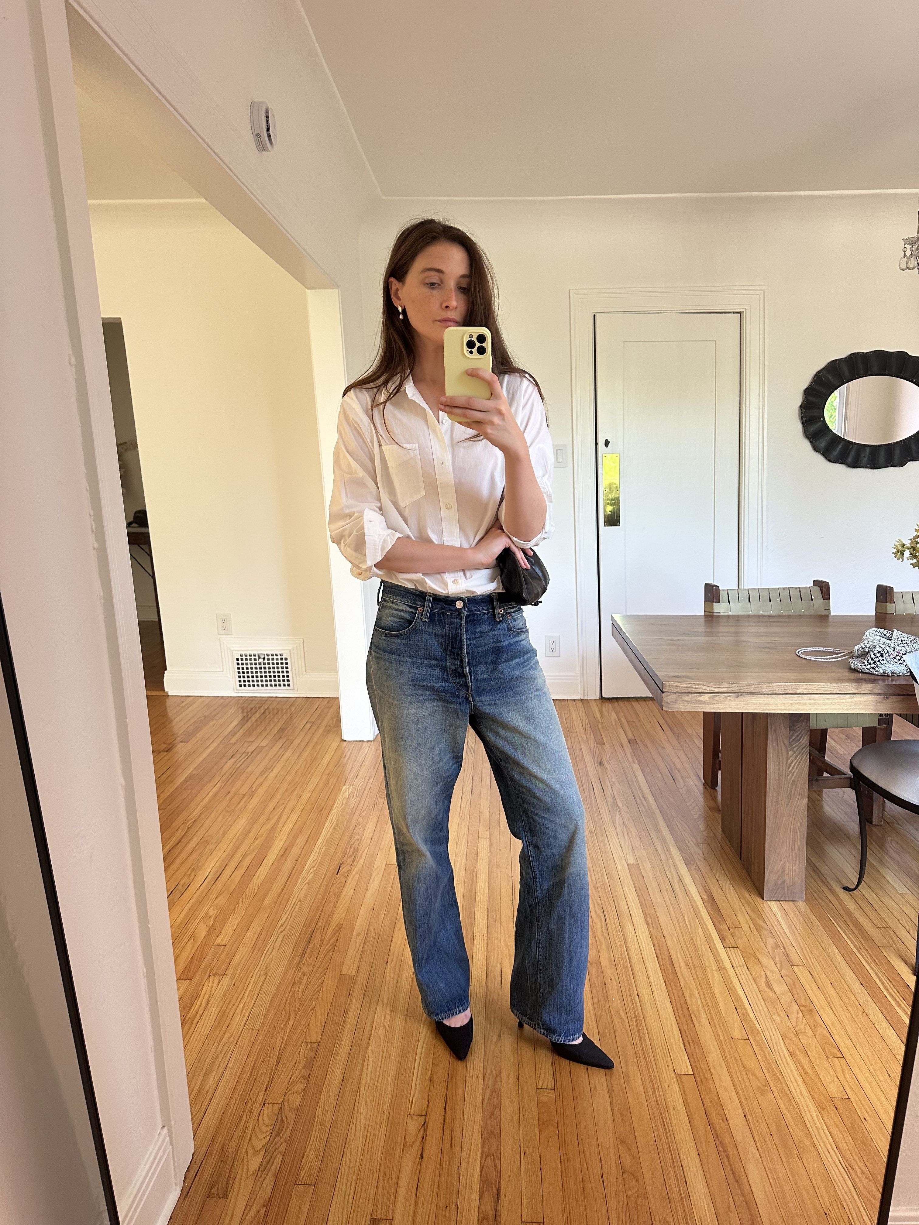Grace O'Neill Dougherty styles a button-down and jeans, both from Buck Mason, with black heels