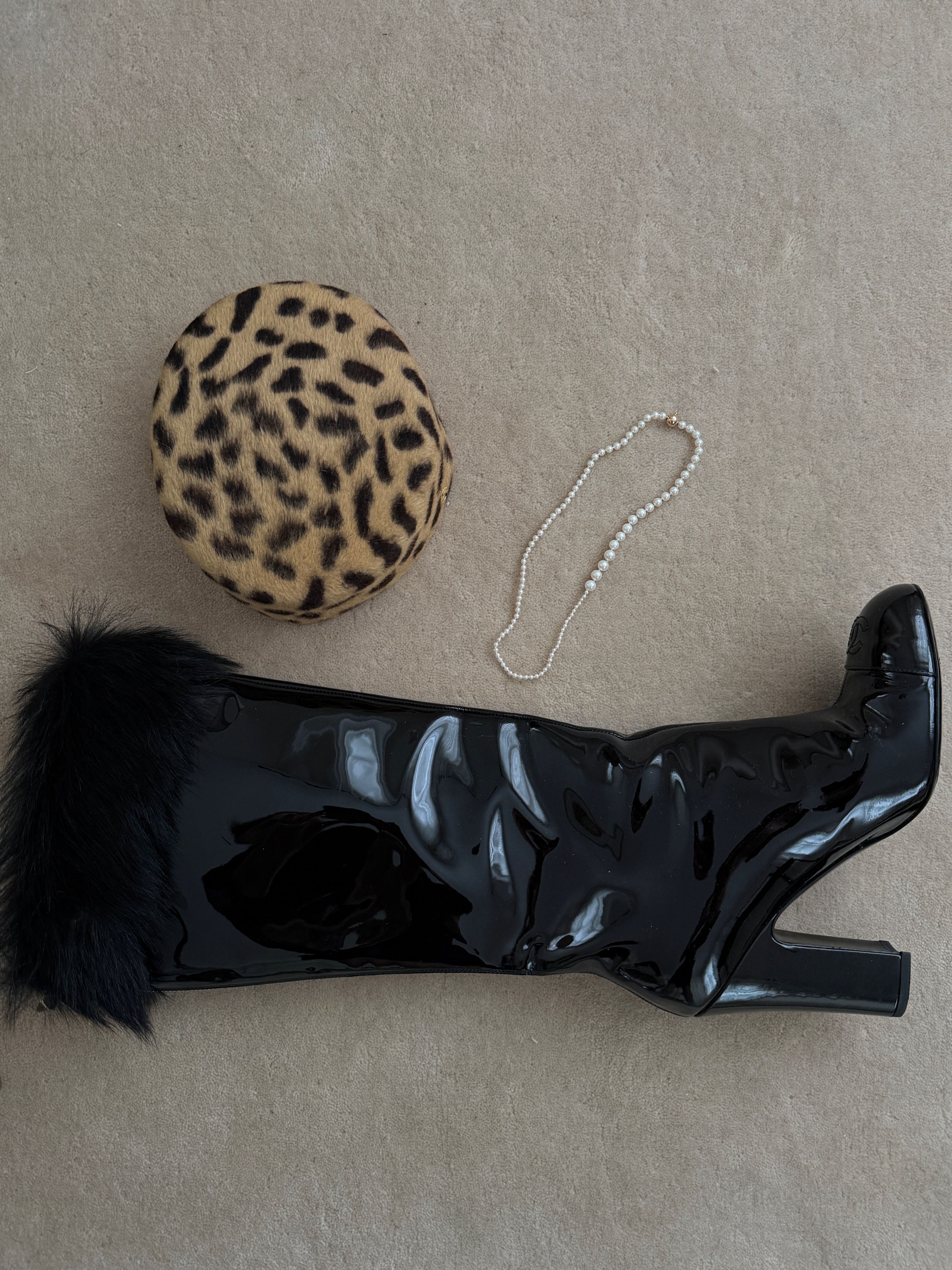 Christie Tyler's black boot and leopard print purse and necklace on the floor