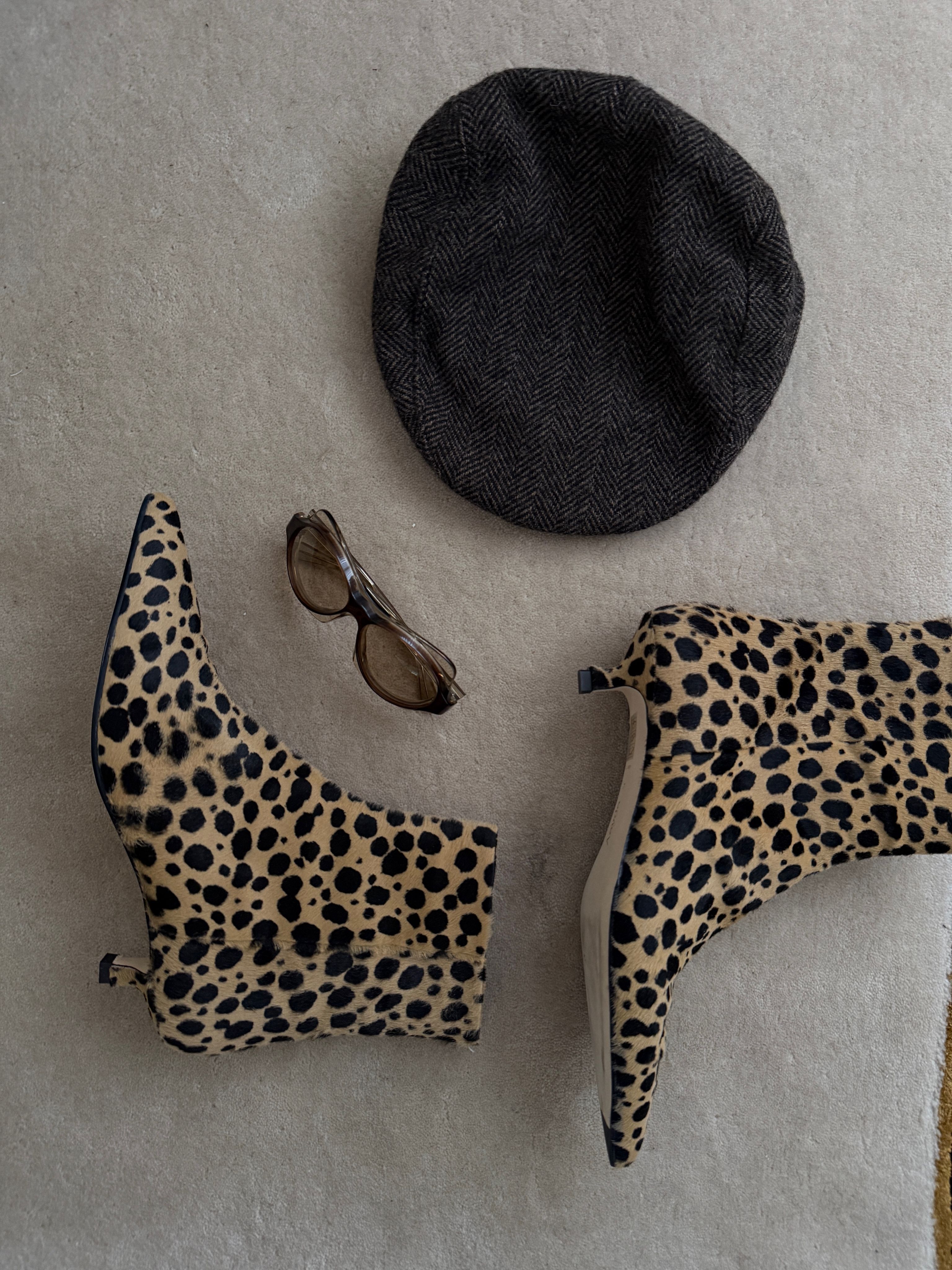 Christie Tyler's leopard print shoes on the floor next to sunglasses and a hat