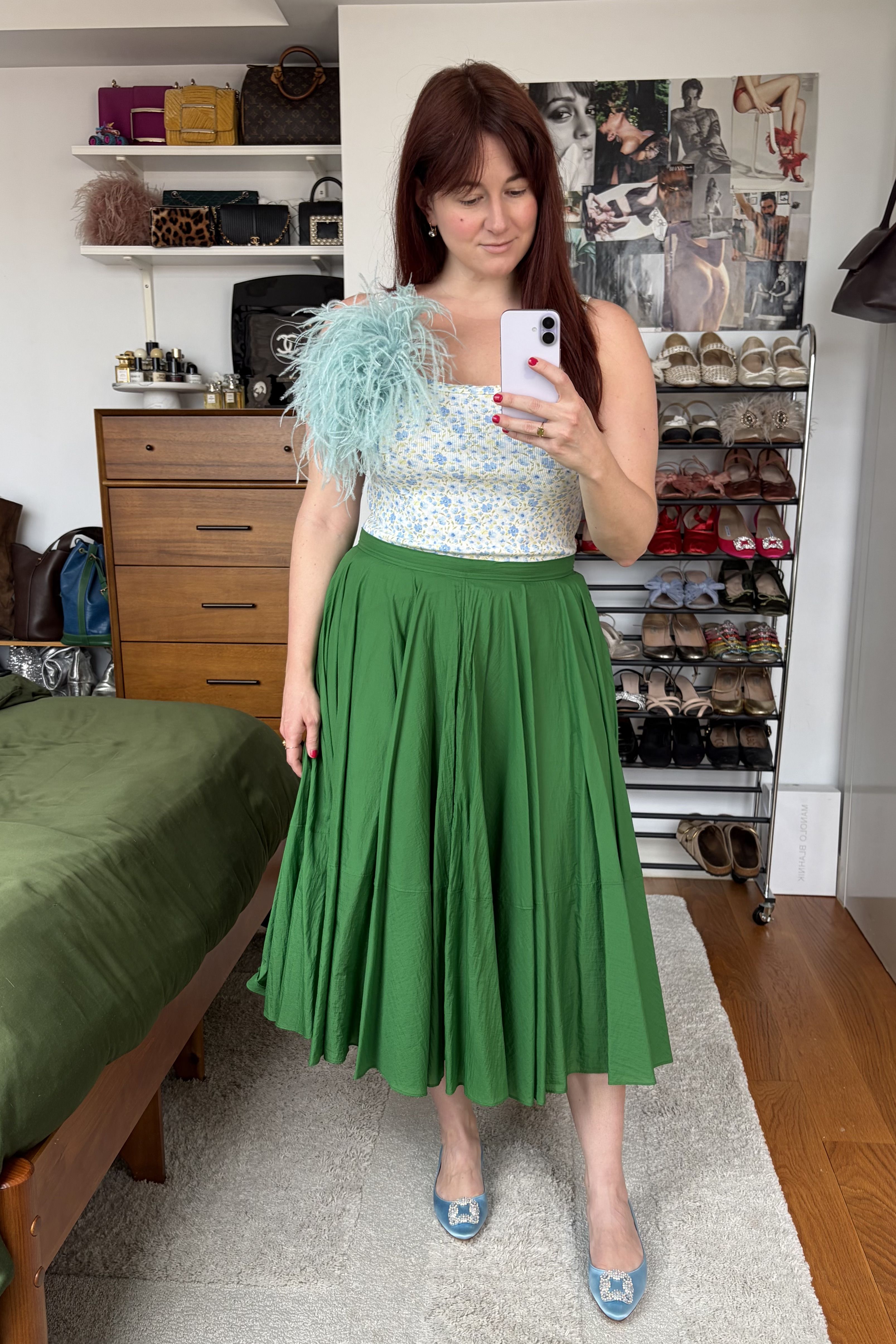 Tyler McCall dresses up an Old Navy tank top with a fun skirt and oversized feather brooch