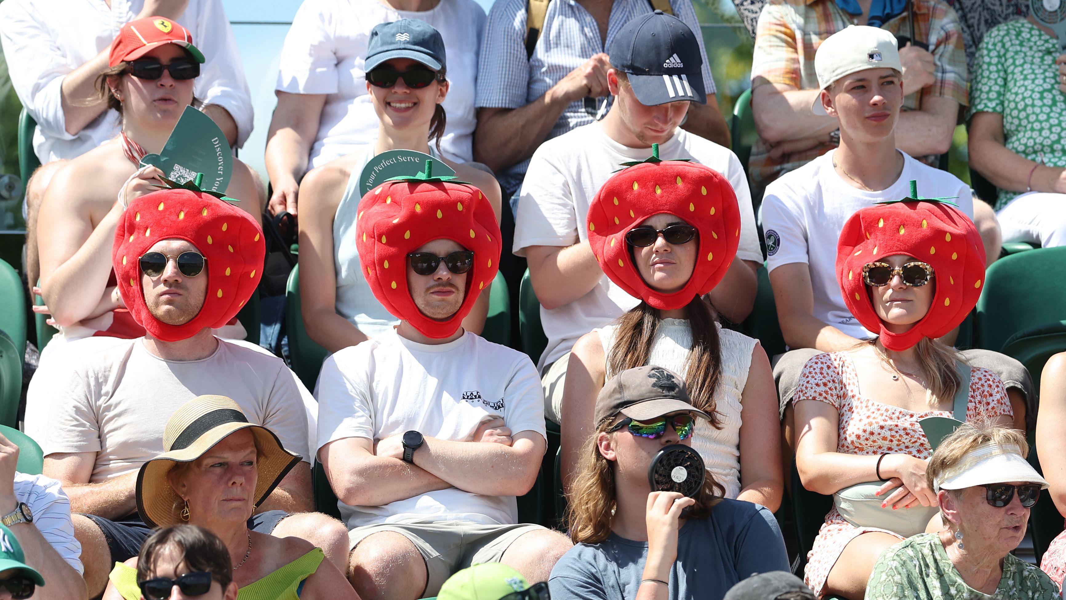 LONDON, ENGLAND - JUNE 30: Wimbledon spectators dressed as strawberries during day one of The Championships Wimbledon 2025 at All England Lawn Tennis and Croquet Club on June 30, 2025 in London, England. (Photo by Rob Newell - CameraSport via Getty Images)