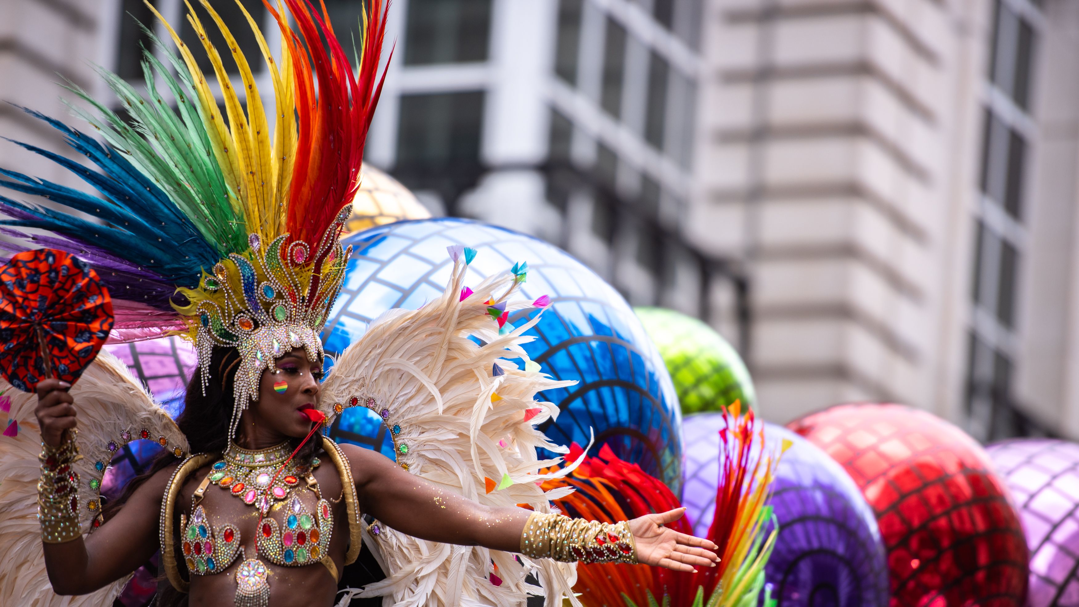 LONDON, ENGLAND, UNITED KINGDOM - 2025/07/05: A participant dressed in colourful feathers greets spectators as the LGBTQ+ Community celebrates London Pride 2025. (Photo by Loredana Sangiuliano/SOPA Images/LightRocket via Getty Images)