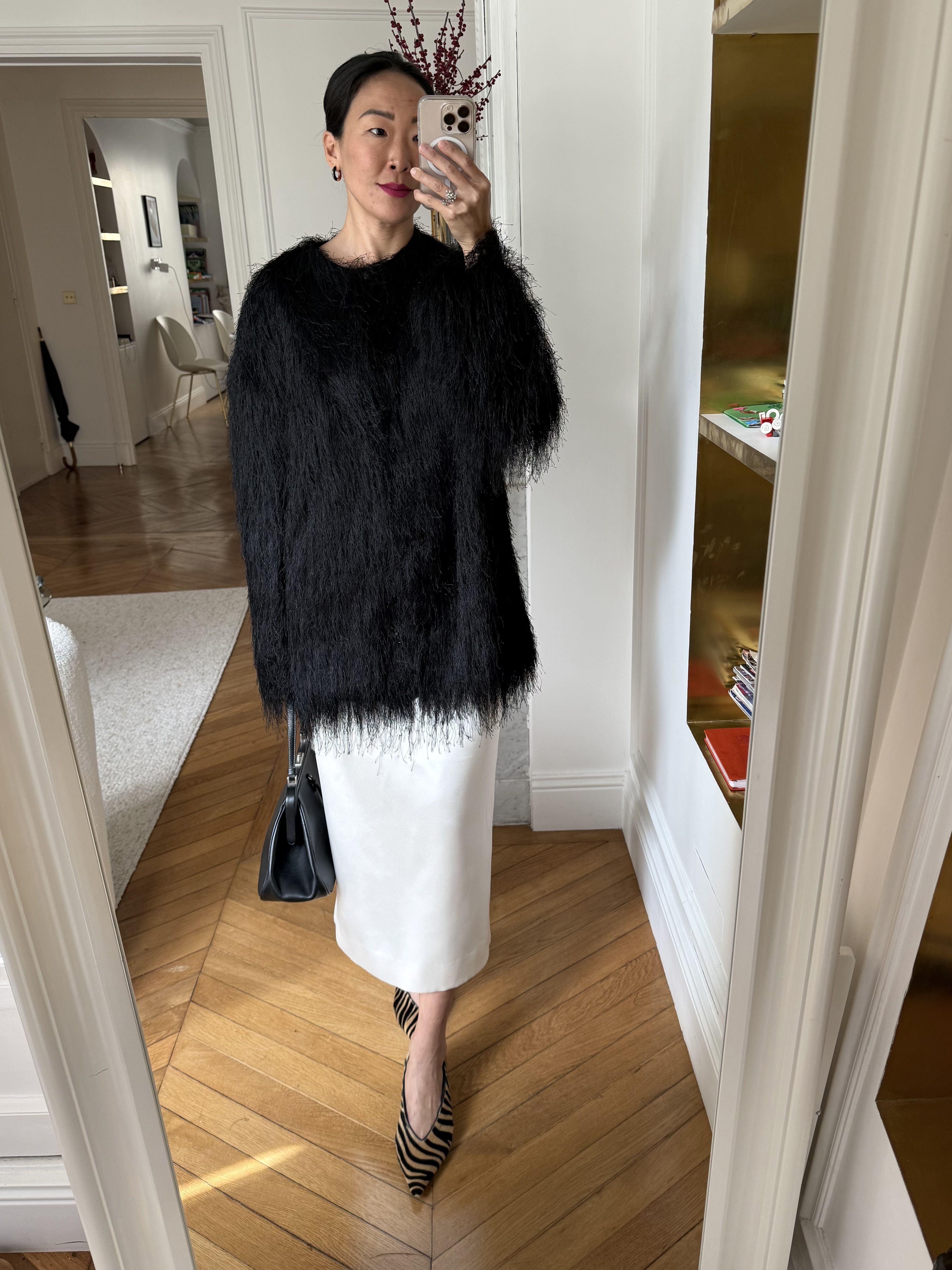 Irene Kim wears a black fringe jacket by Loulou de Saison
