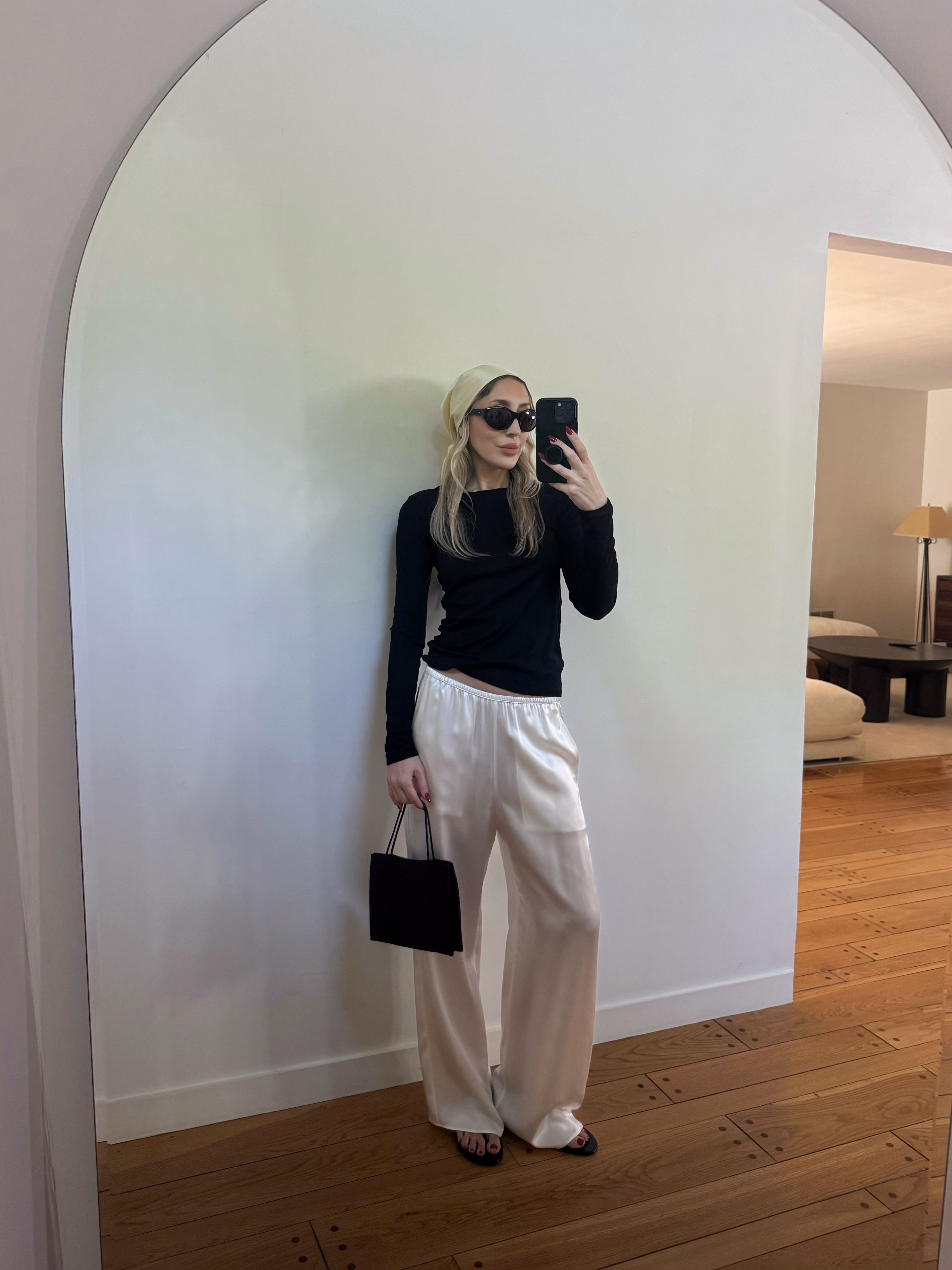 Angela Fink adds visual interest to a black and white contrast outfit with a scarf worn on her head
