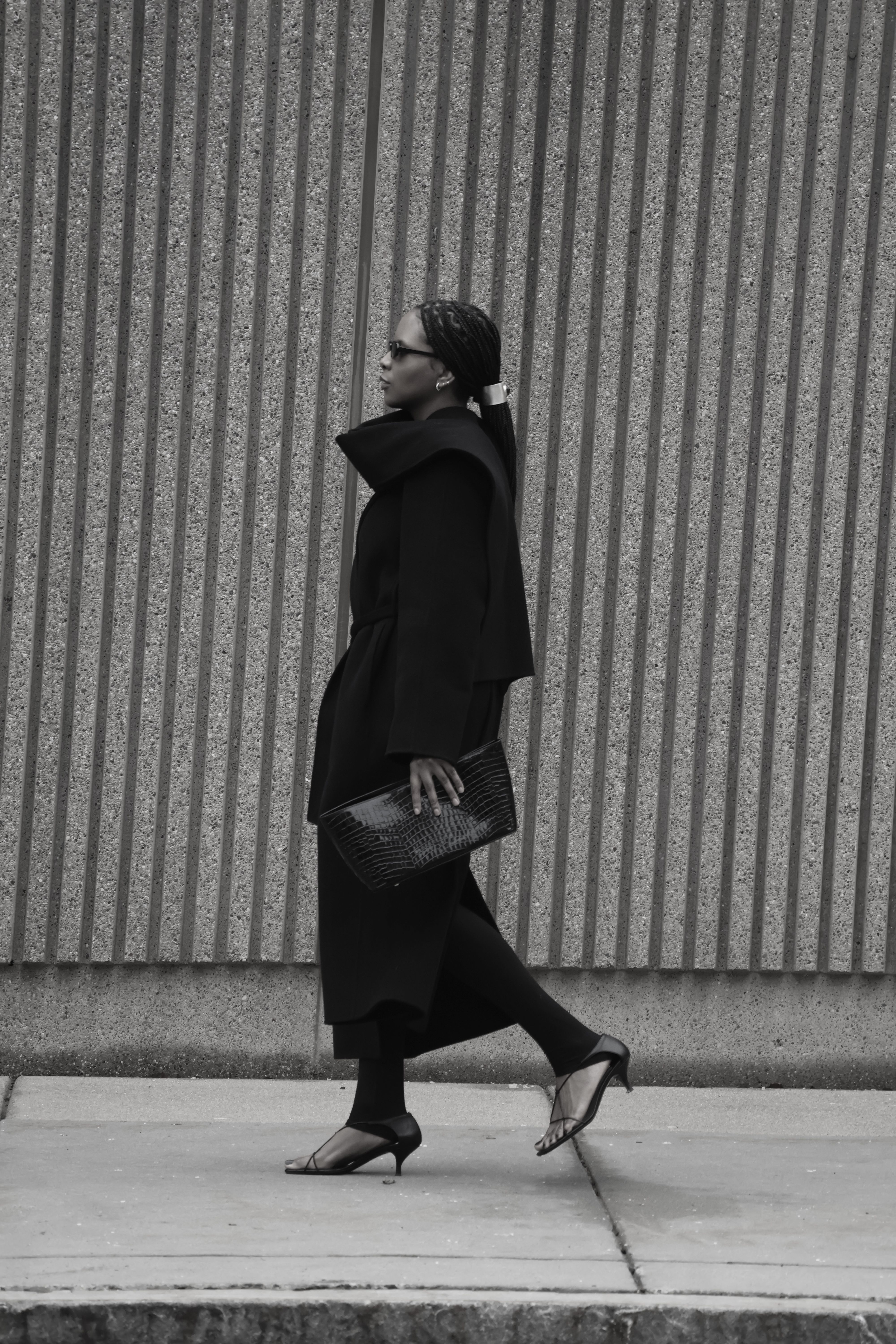 Maya Moore wears a kitten-heel black sandal with a tailored all-black look