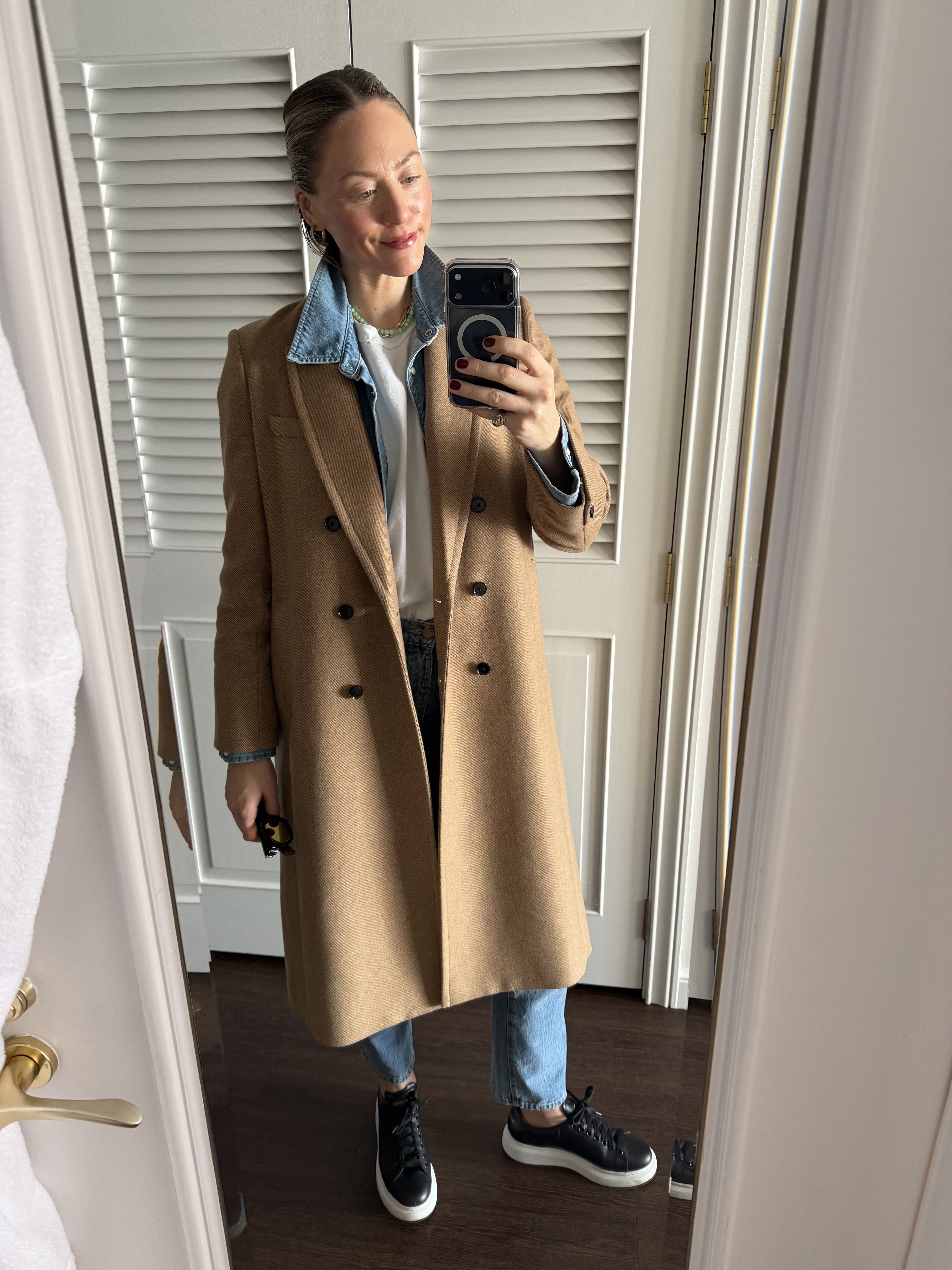 Brooke Ely Danielson styles denim on denim with a beige peacoat