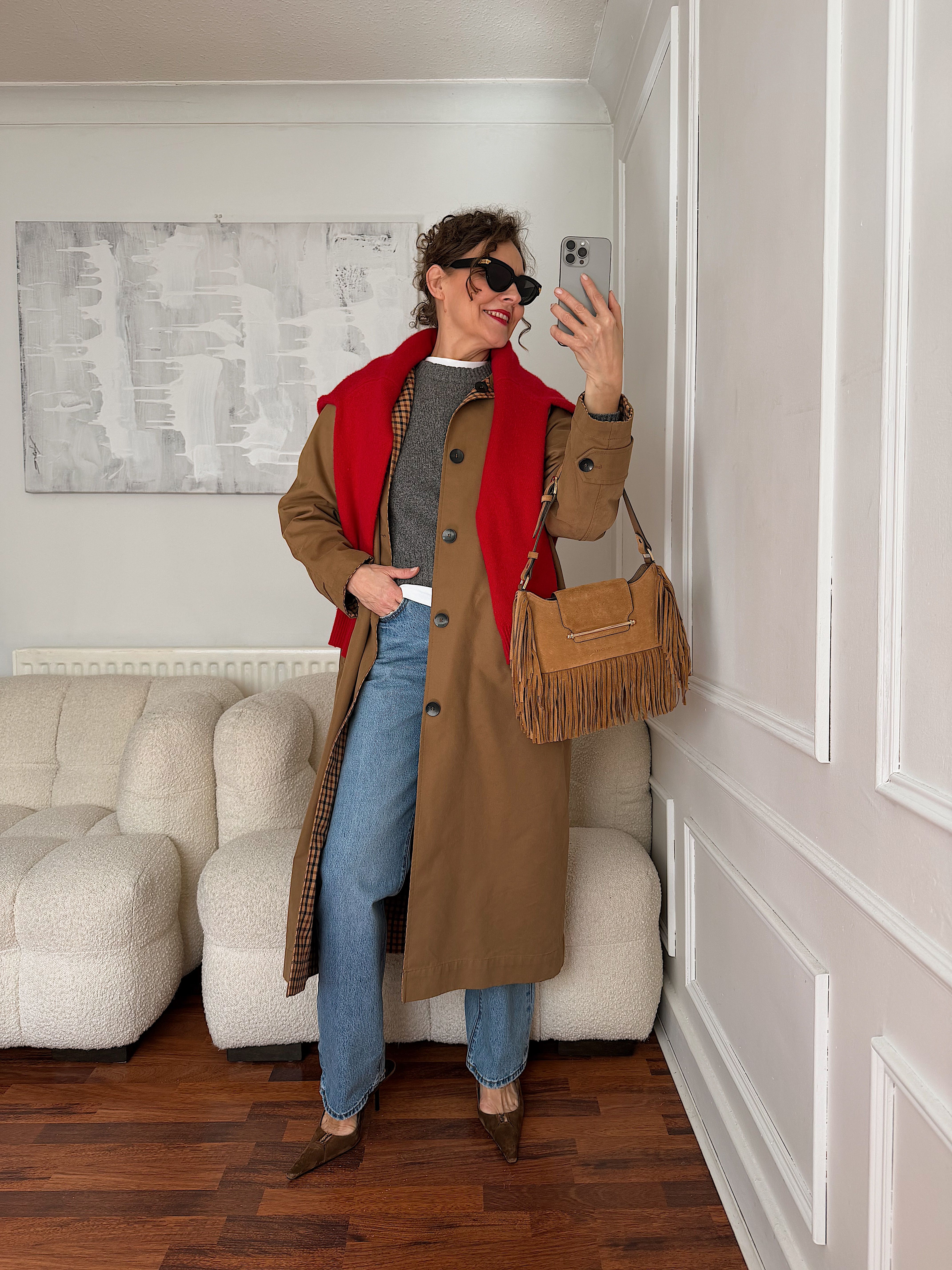 Renia Jazdzyk cuts a classic outfit with a red sweater
