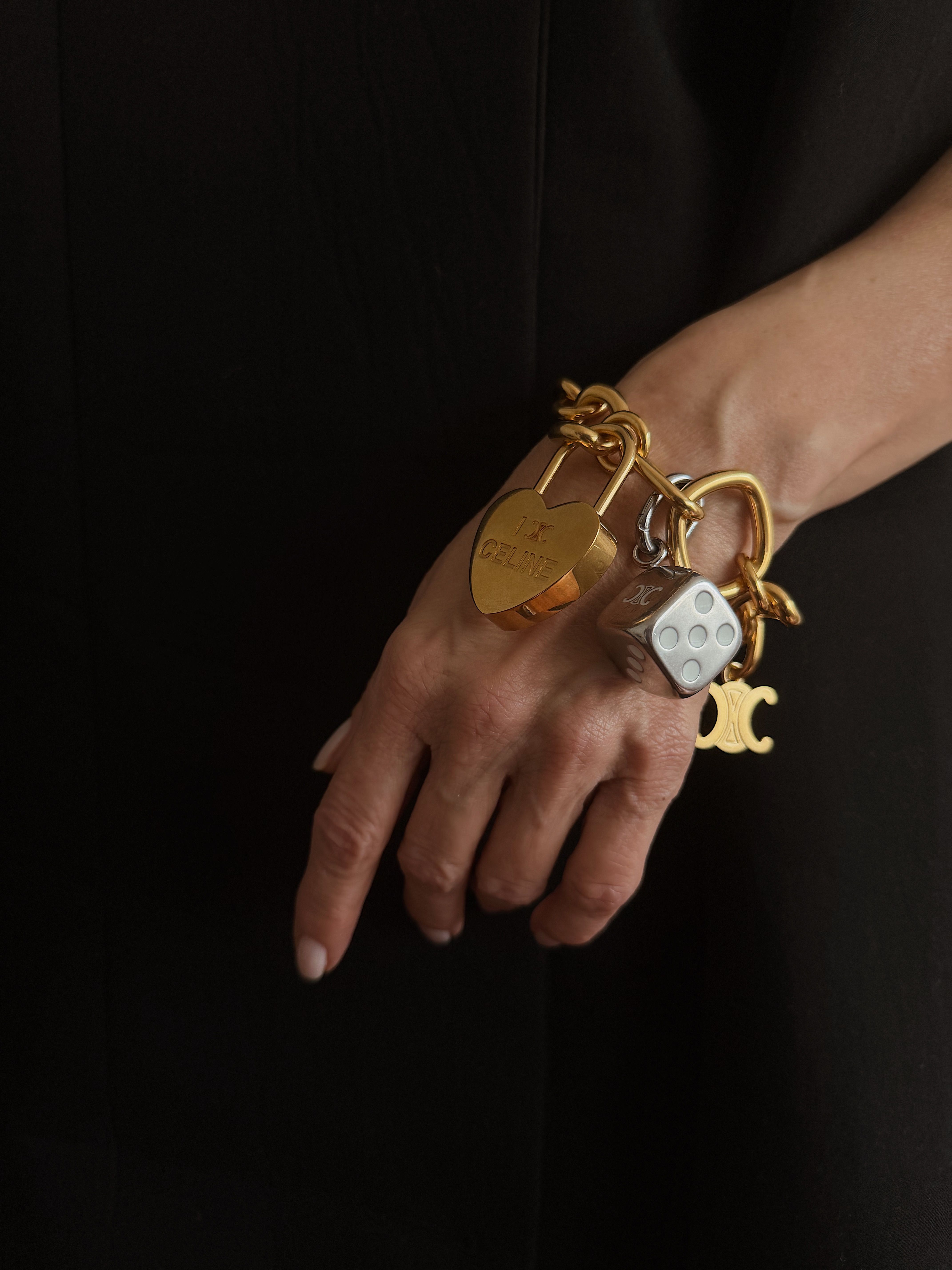 Renia Jazdzyk wears a chunky charm bracelet from C&amp;eacute;line with assorted a die, heart and C&amp;eacute;line double-C