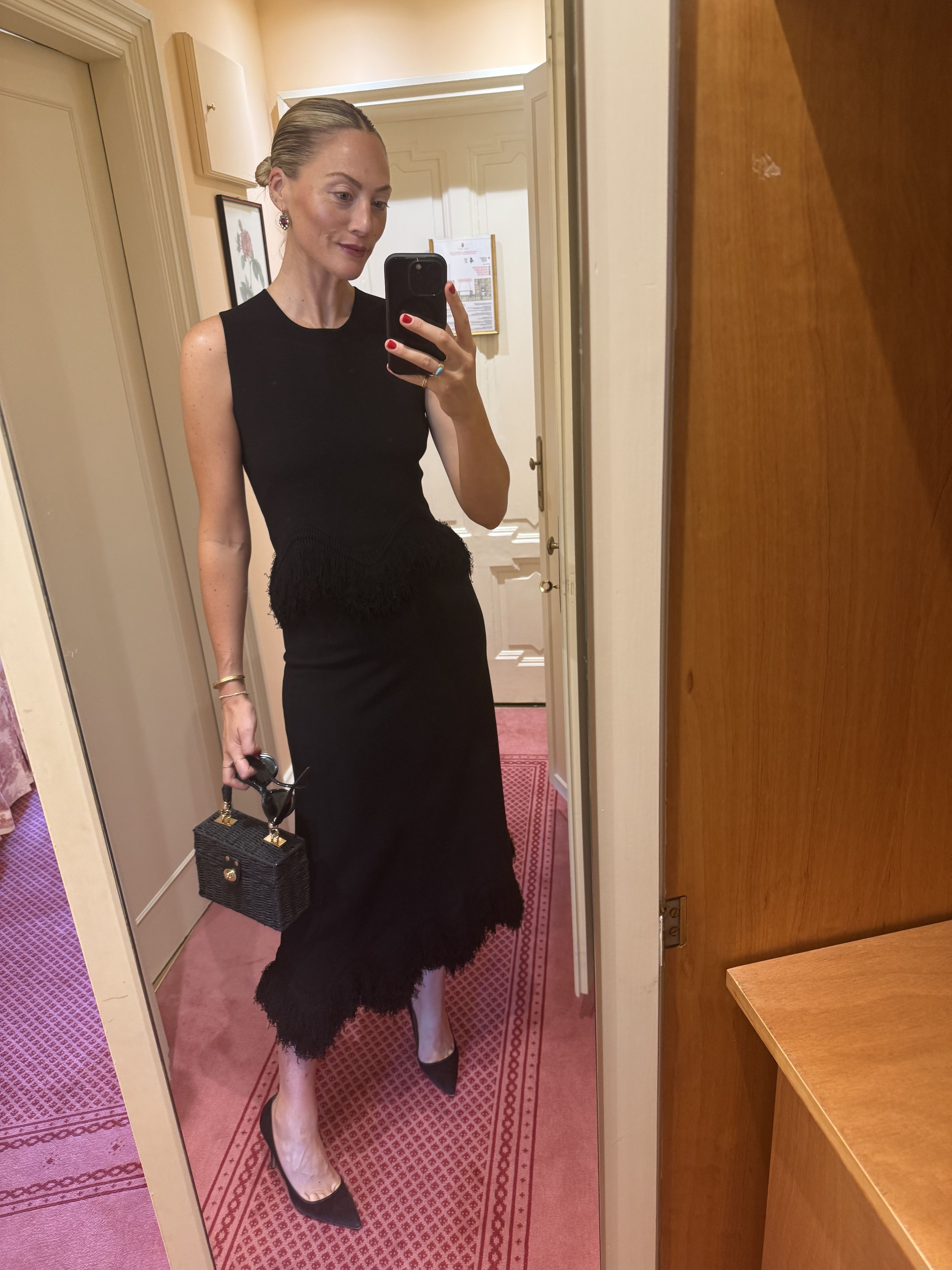 Mirror selfie of Brooke Ely Danielson styling a black knit set for summer