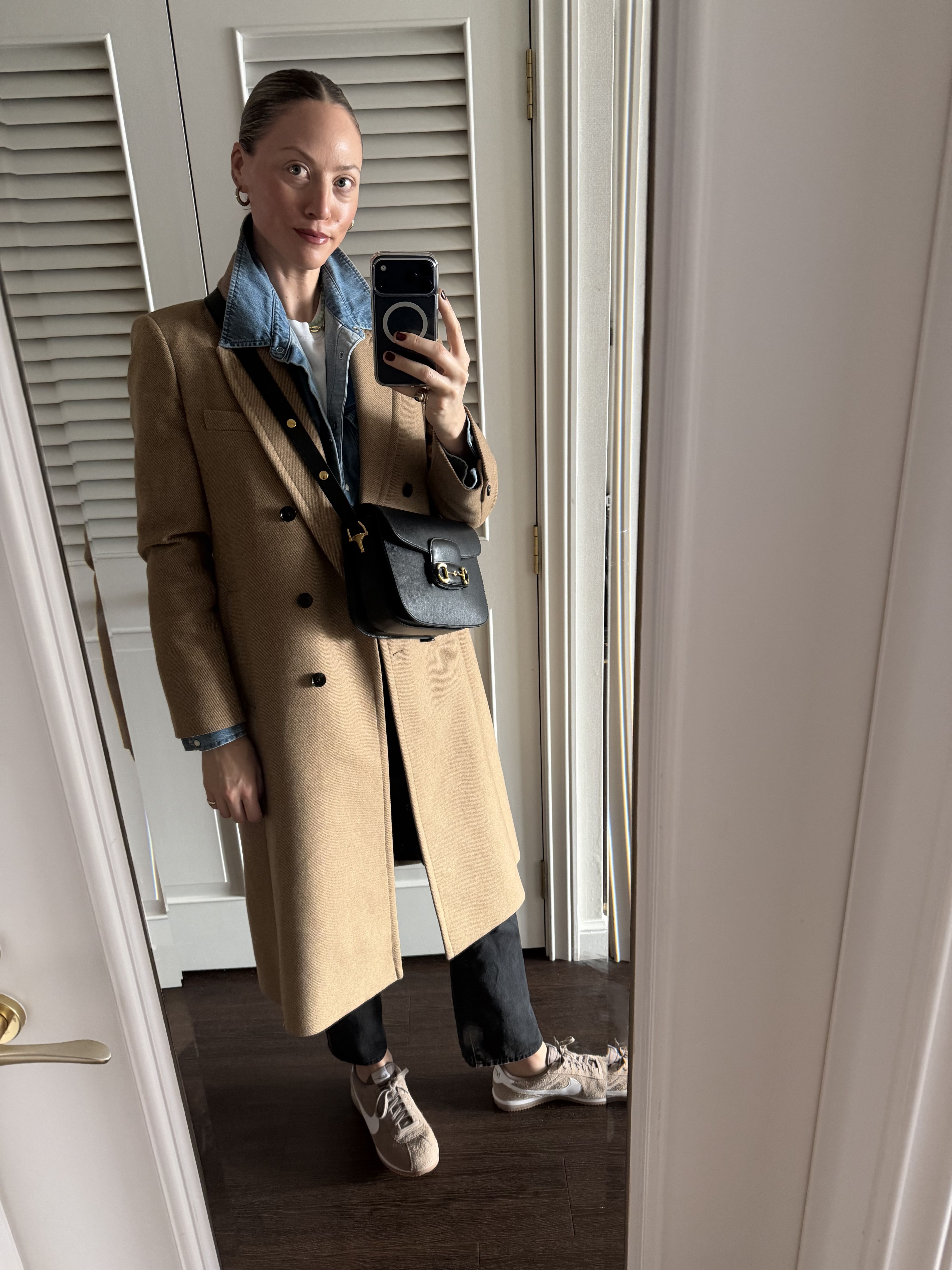 Brooke Ely Danielson styles a pair of Nike Cortez with a tan coat and denim layers