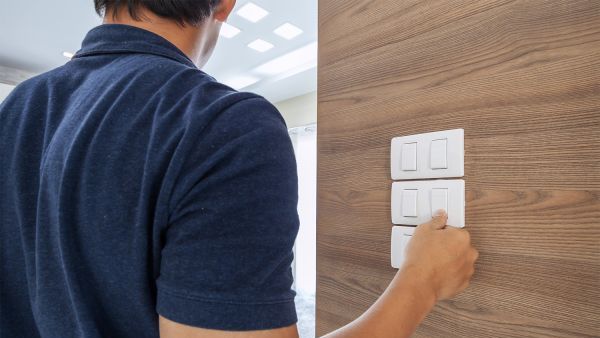 Man using light switches