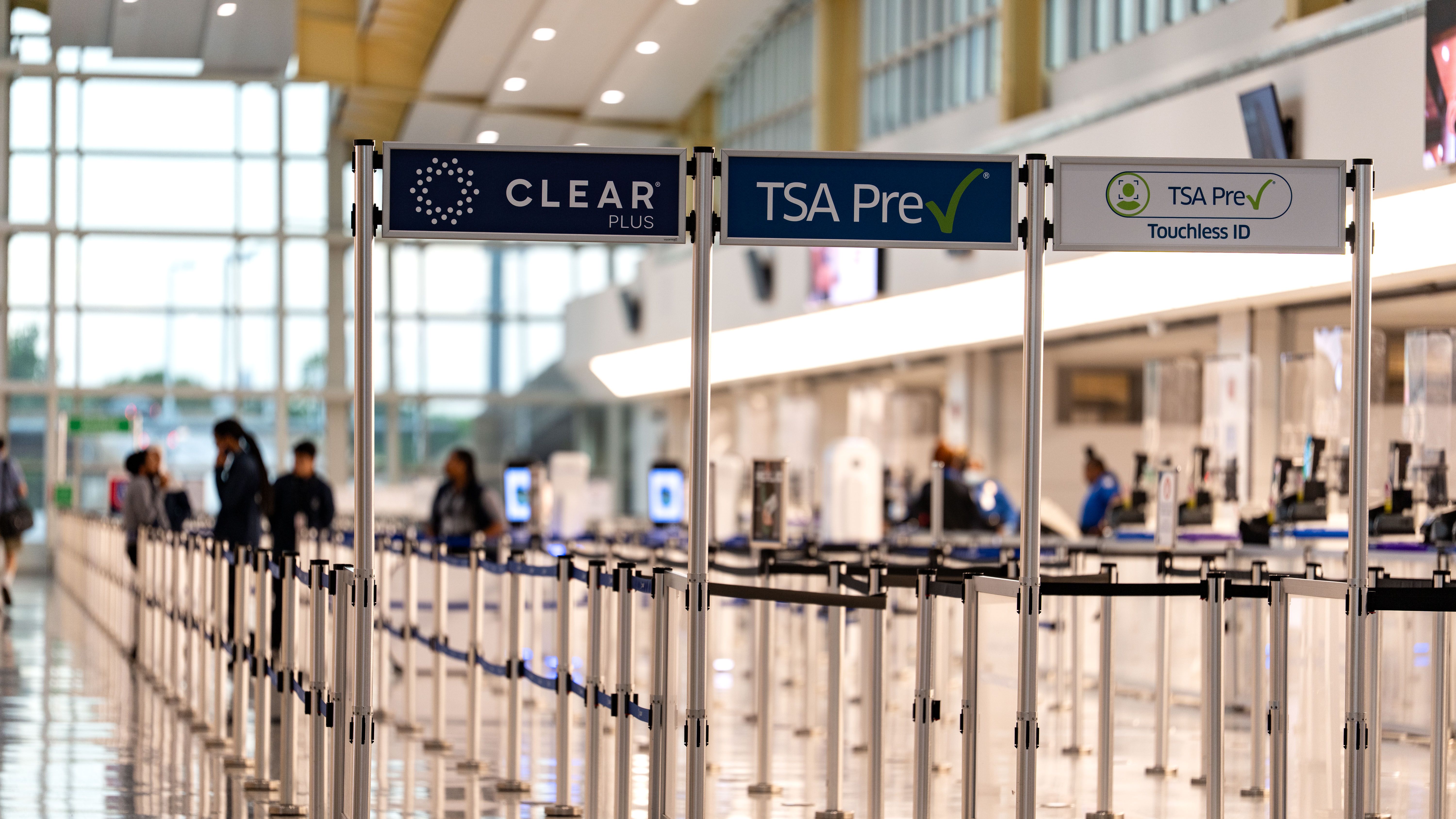 Three airport security lines, each labeled Clear, TSA PreCheck and TSA PreCheck Touchless ID. All three are relatively empty.