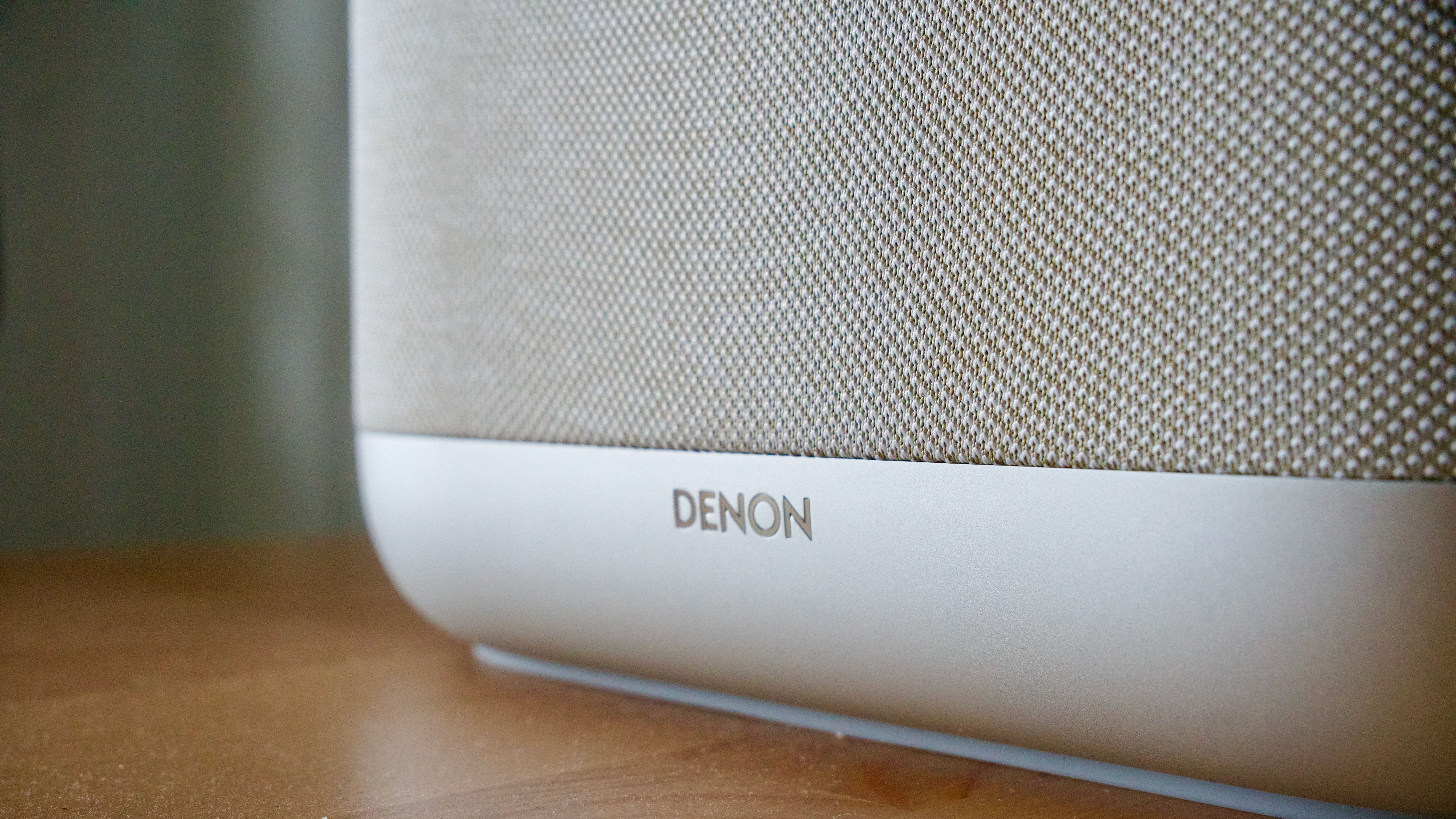 Denon Home 400 home speaker on a wooden surface