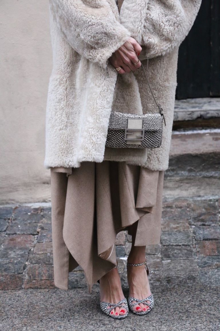 Larissa Mills styles sparkly sandals with a matching shoulder bag and fluffy coat