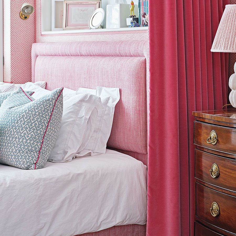 pink bedroom with wooden chest of drawers