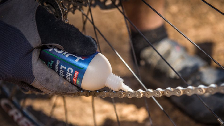 Squirt only lasting chain lube being applied to a chain