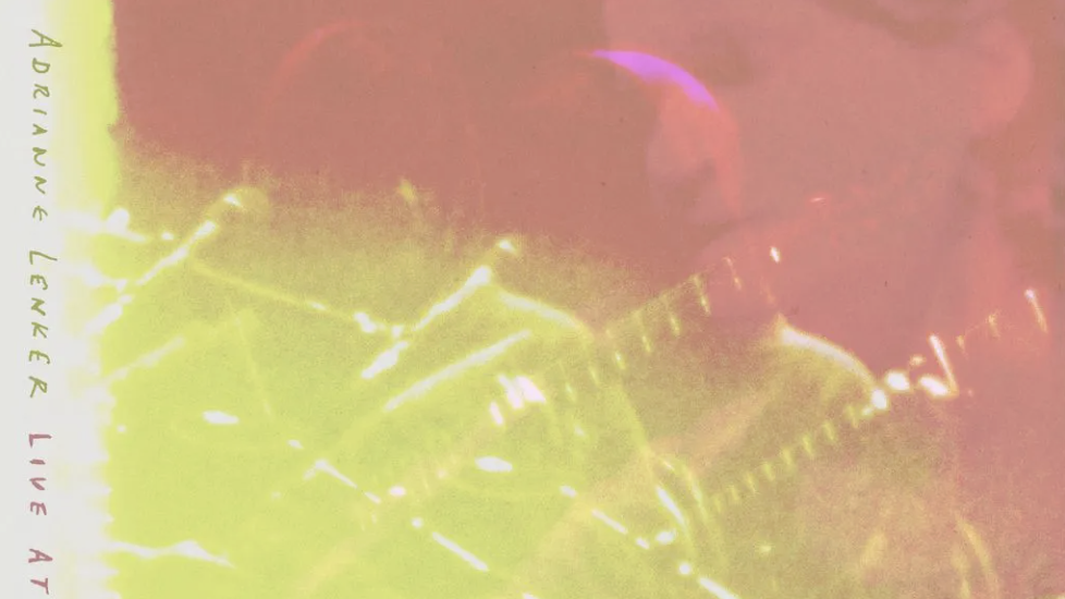 An over-saturated image of a guitarist in pink and yellow, with some text along the left edge