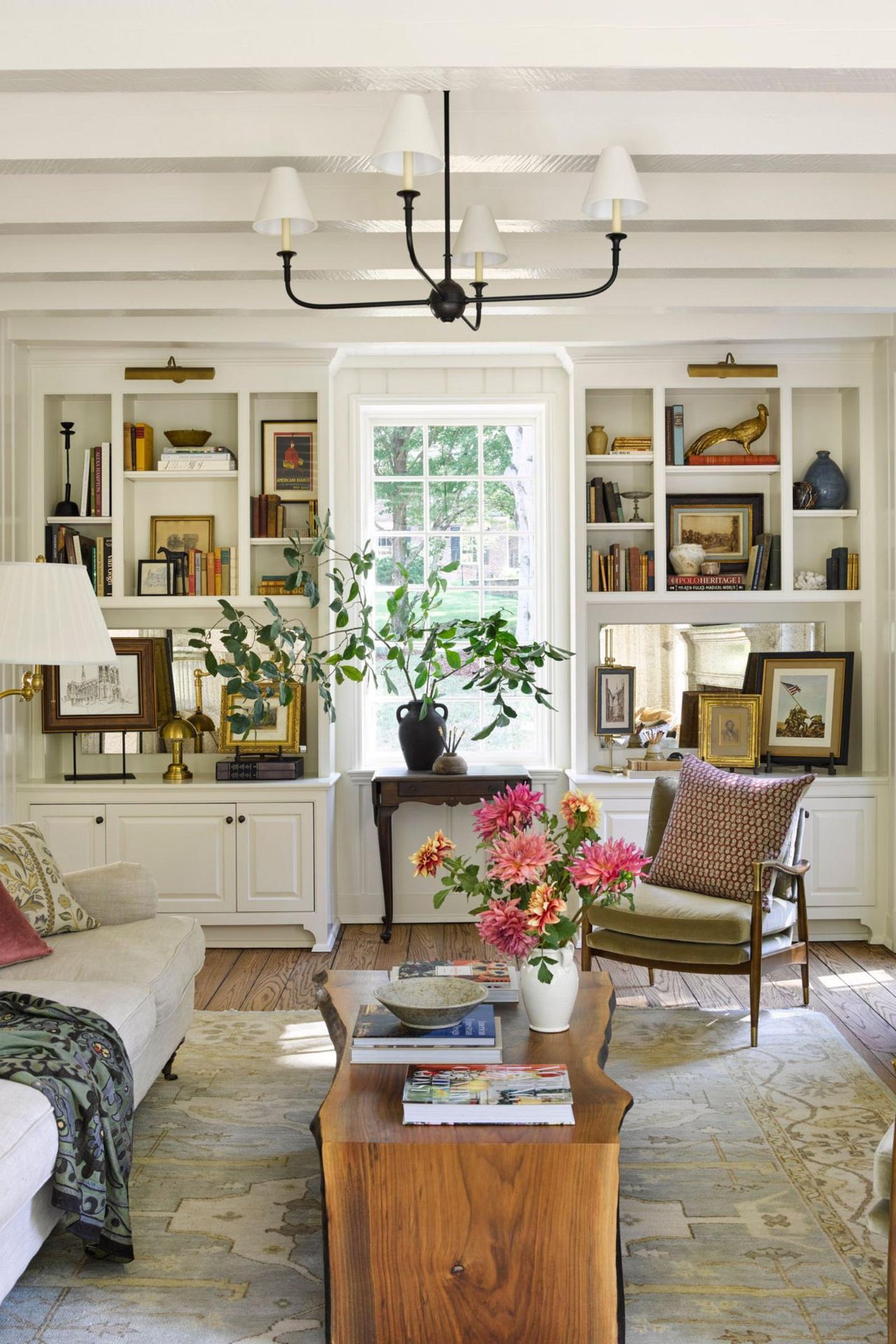 side by side living room interiors with a vintage collected neutral living room on the left and a soft green color drenched living room on the right with an L shaped couch