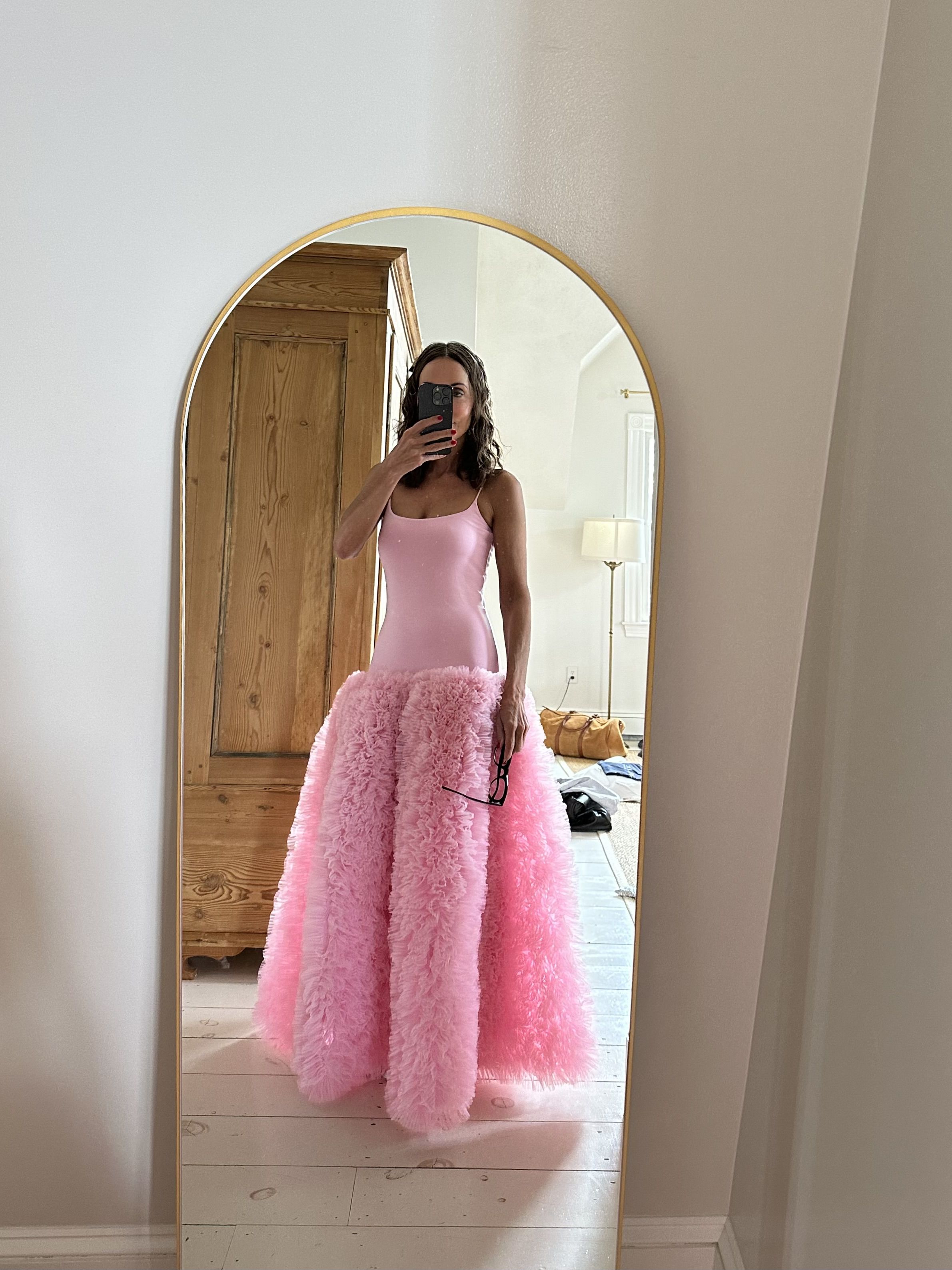 Larissa Mills wears a Carrie Bradshaw-inspired bubblegum pink party dress with a dropped waist and textured tulle skirt