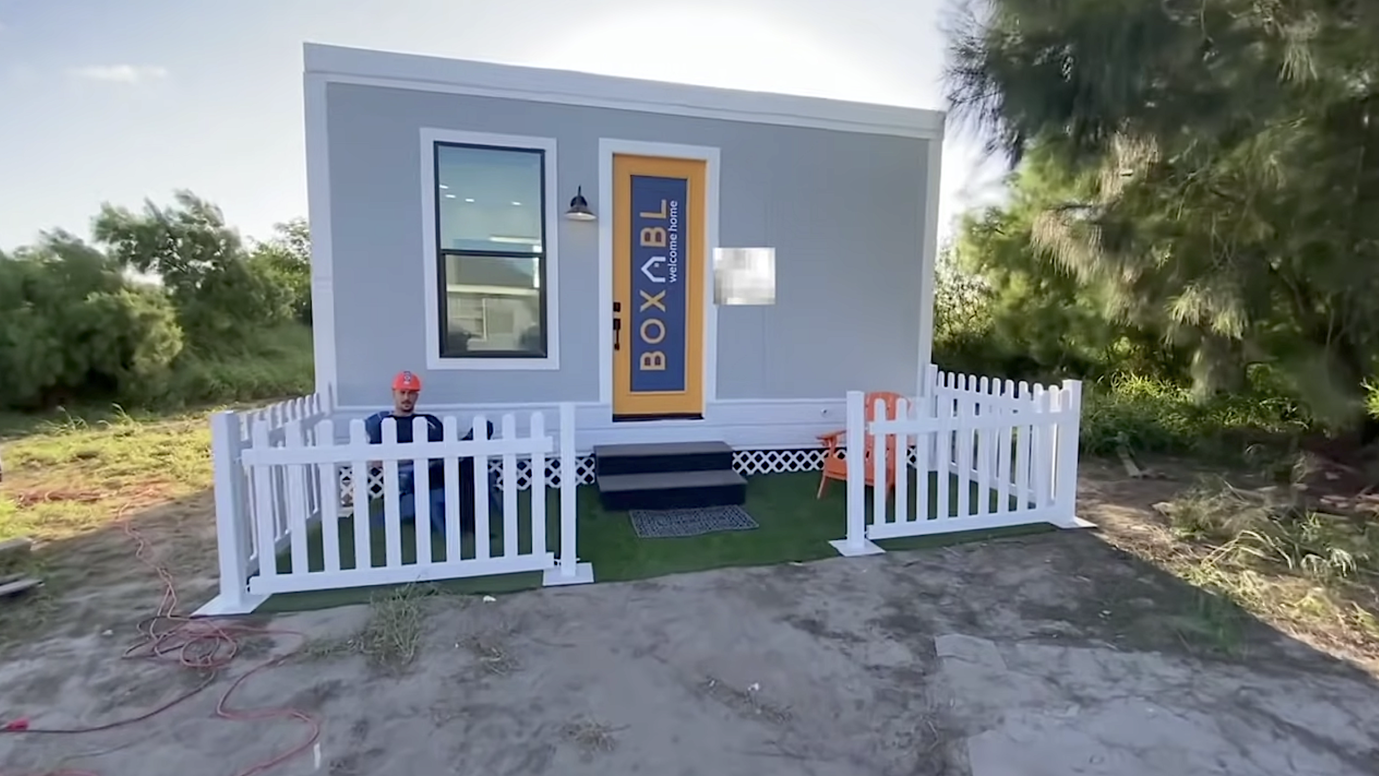 A compact Boxabl Casita prefab home with a white fence, representing Elon Musk’s reported $50,000 Texas residence near SpaceX’s Starbase.