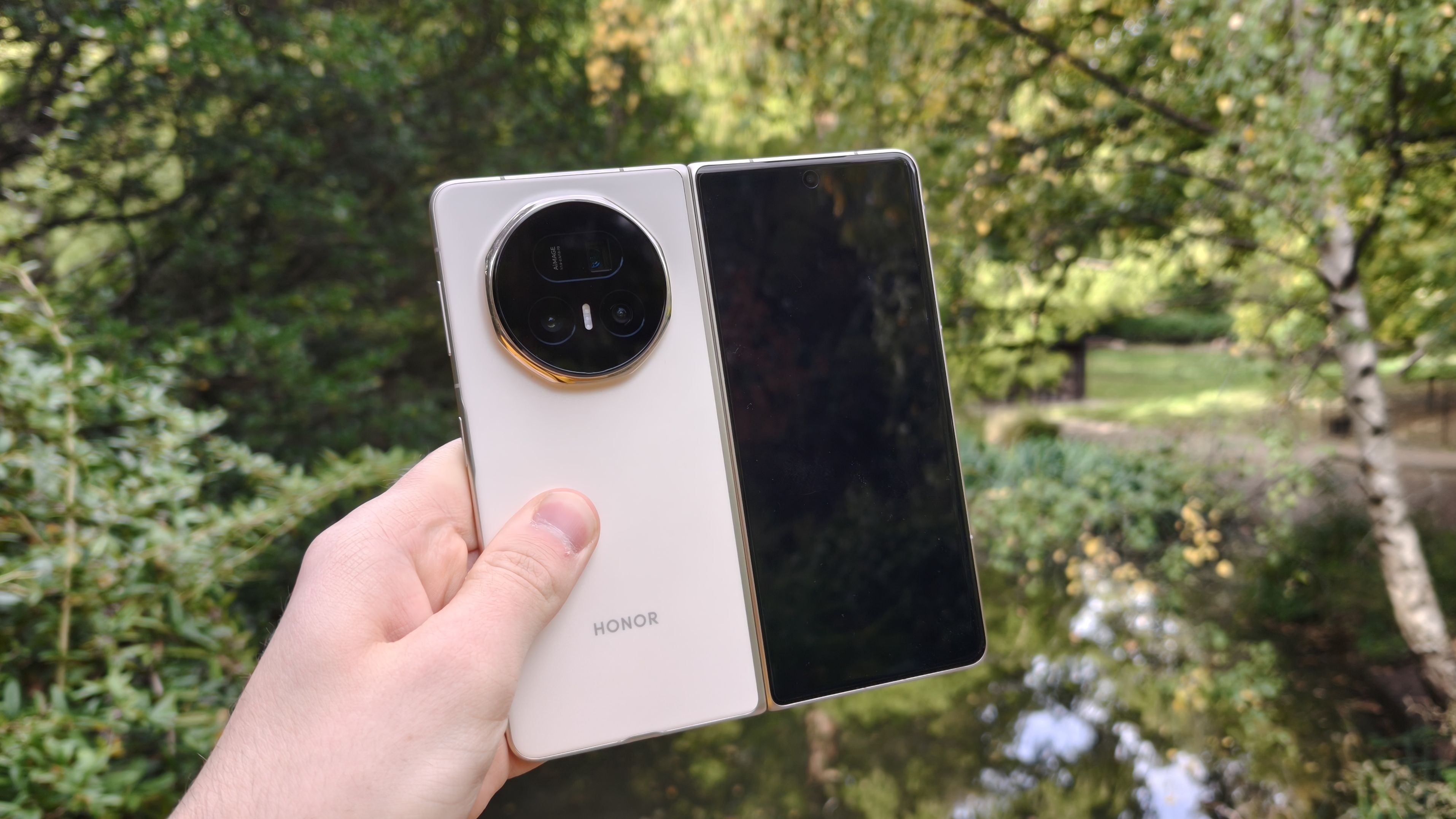 The Honor Magic V5 with a pond in the background