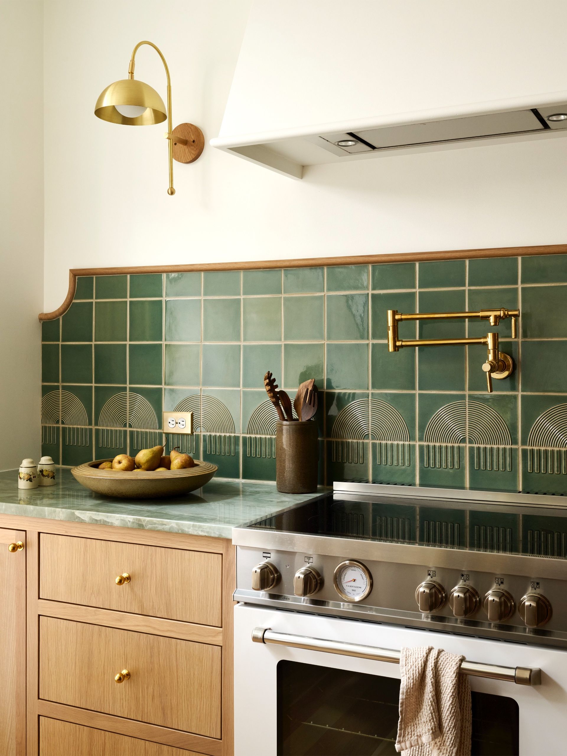 green backsplash with curved detail