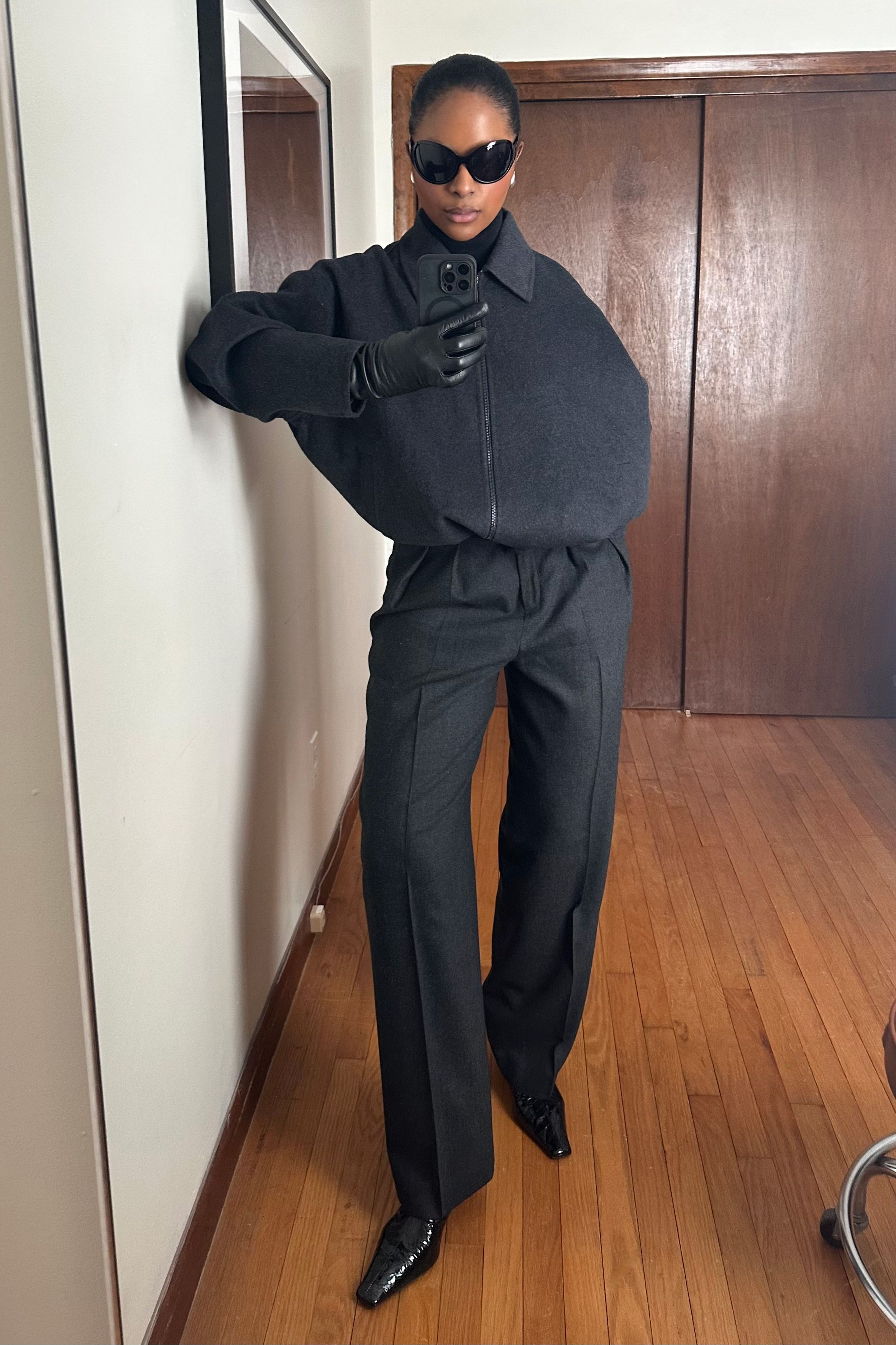 Maya Moore wearing a black jacket, black trousers, and black heels