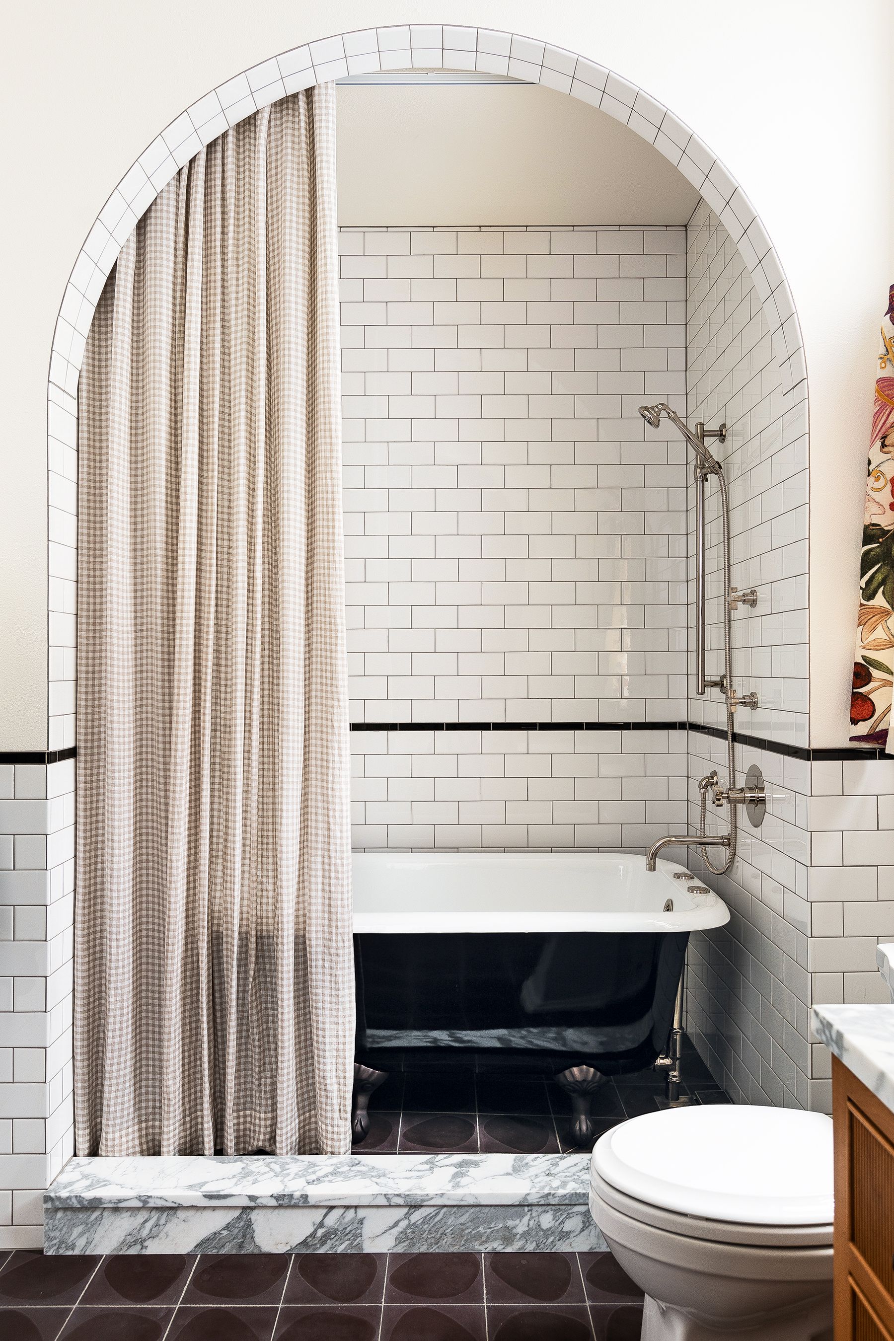 Small bathroom with arched door frame and white metro tiles