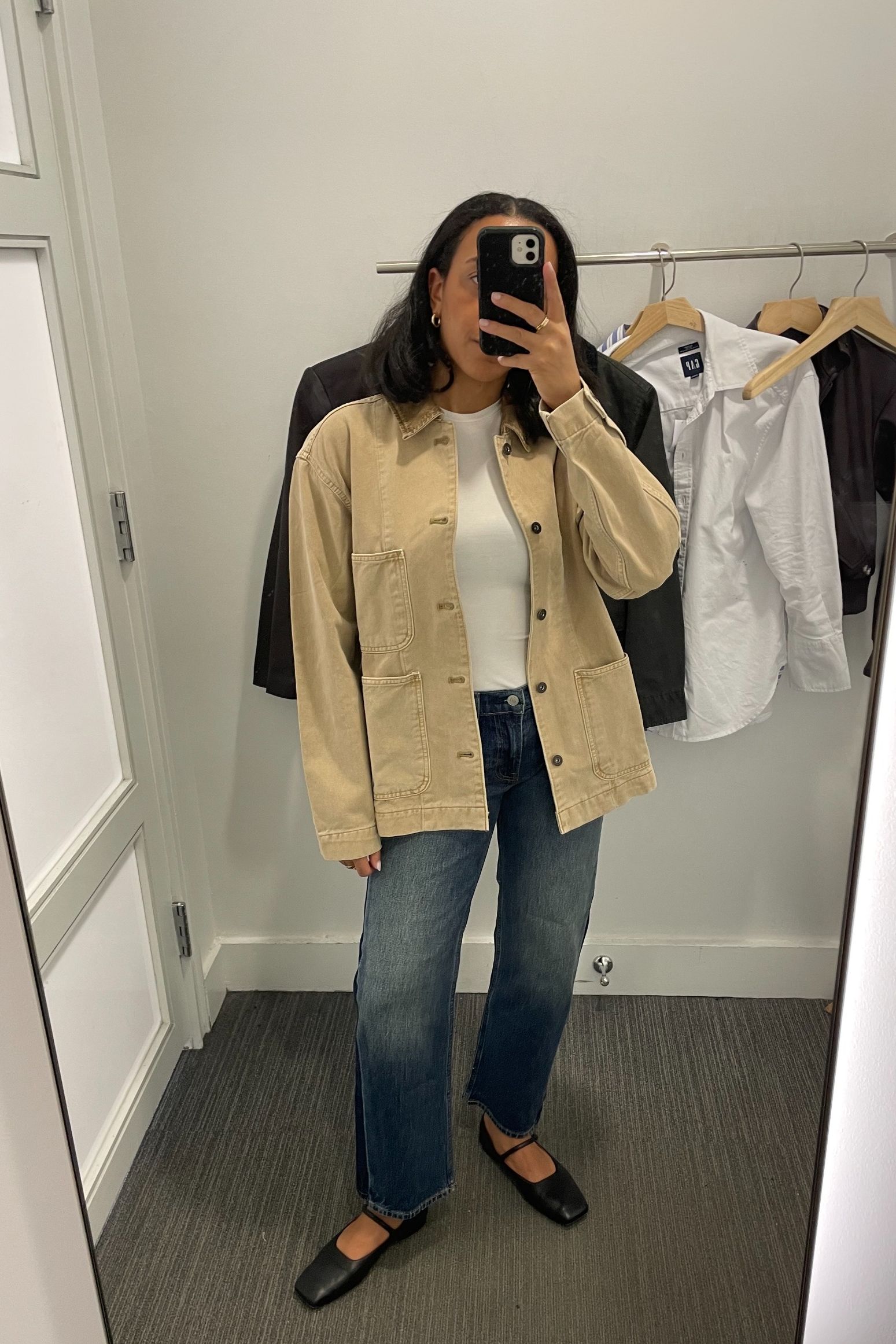Lauren Tappan wearing a barn jacket, a tee, and jeans