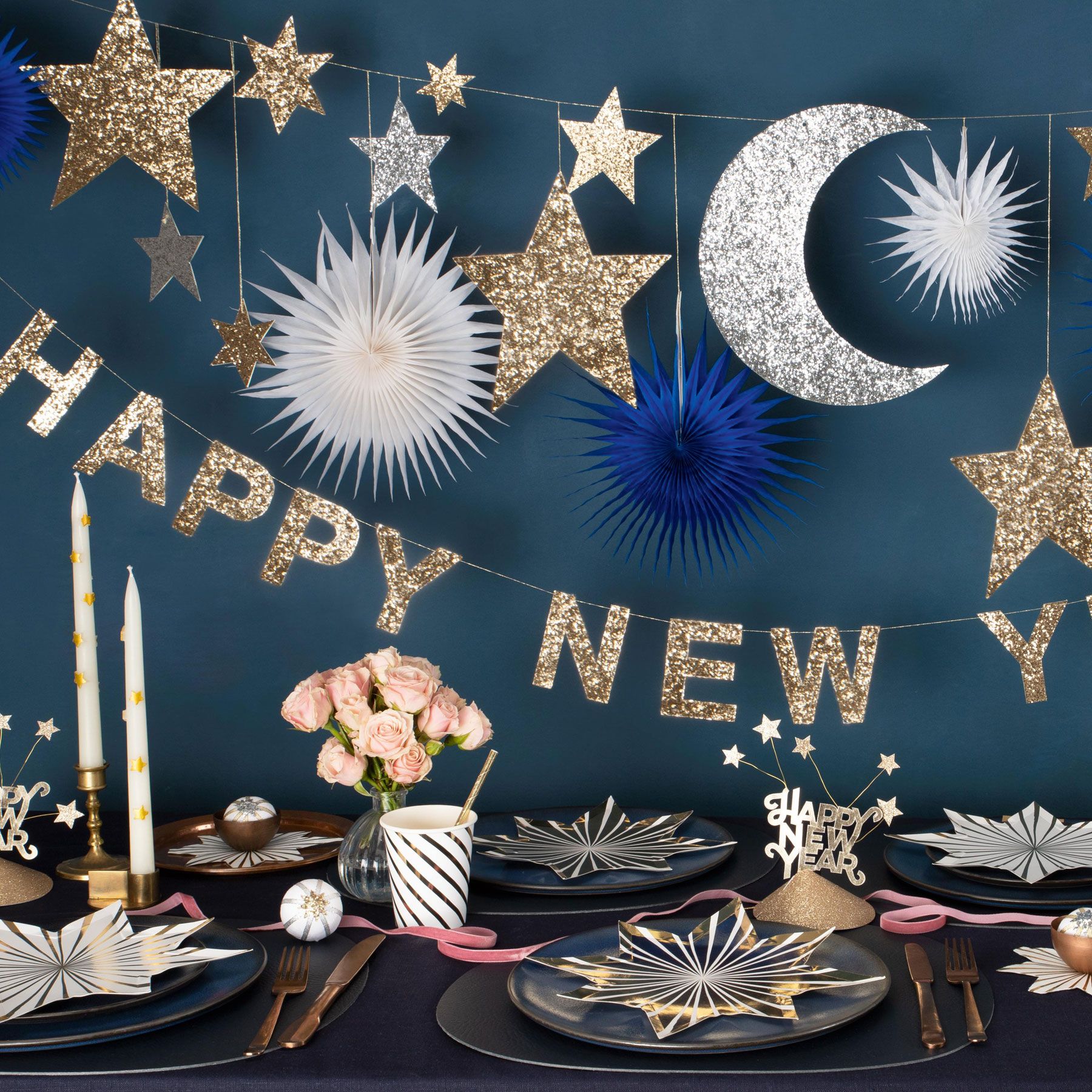 Blue wall with gold, silver and blue bunting spelling out 'Happy New Year'