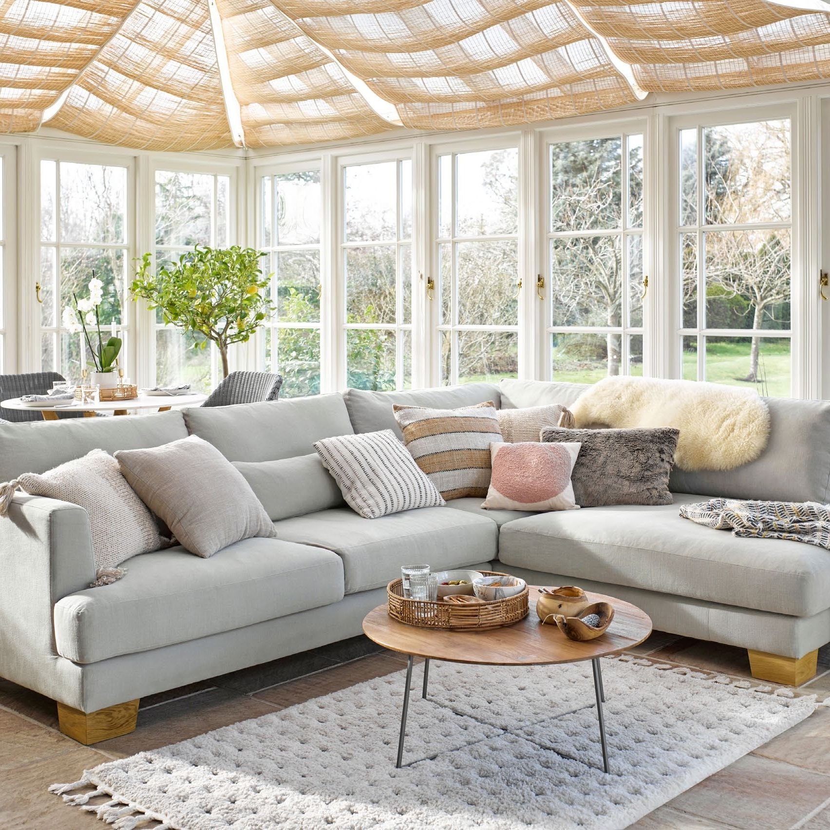 conservatory with natural material blinds and grey furniture