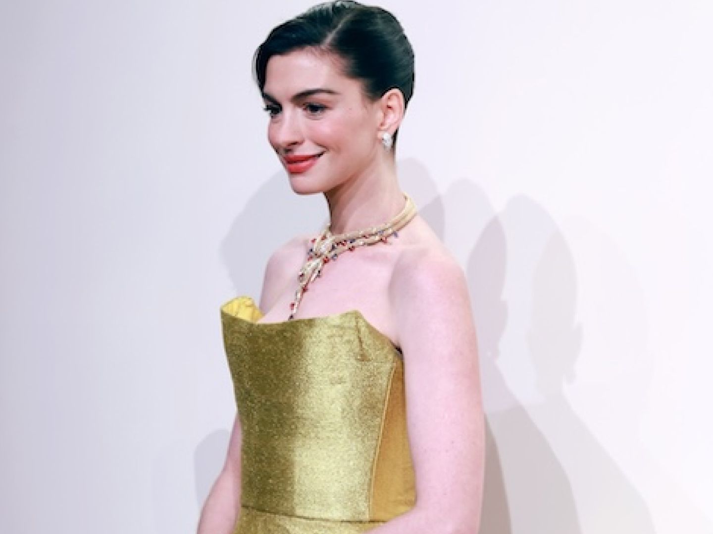Anne Hathaway Goes Audrey Hepburn in a Gold Midi Dress and Bulgari Jewels |  Marie Claire