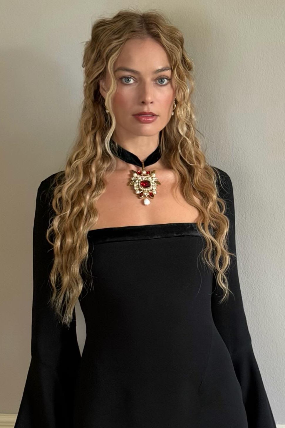 Margot Robbie wears her hair in "Wuthering Heights" style waves