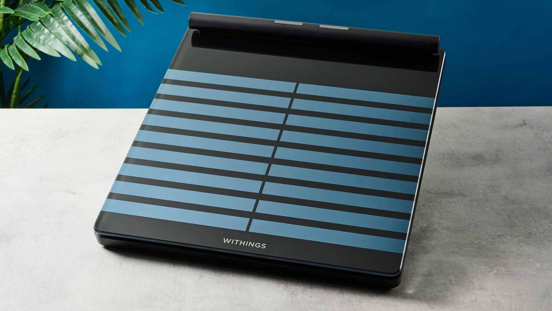 a black tempered glass smart scale with a pull-out ECG monitor showing its sleek modern smart scale finish