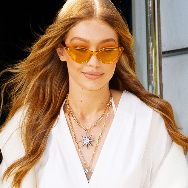 gigi hadid white shirt dress Gigi Hadid Demonstrates How to Wear a Sweater Dress Over Jeans