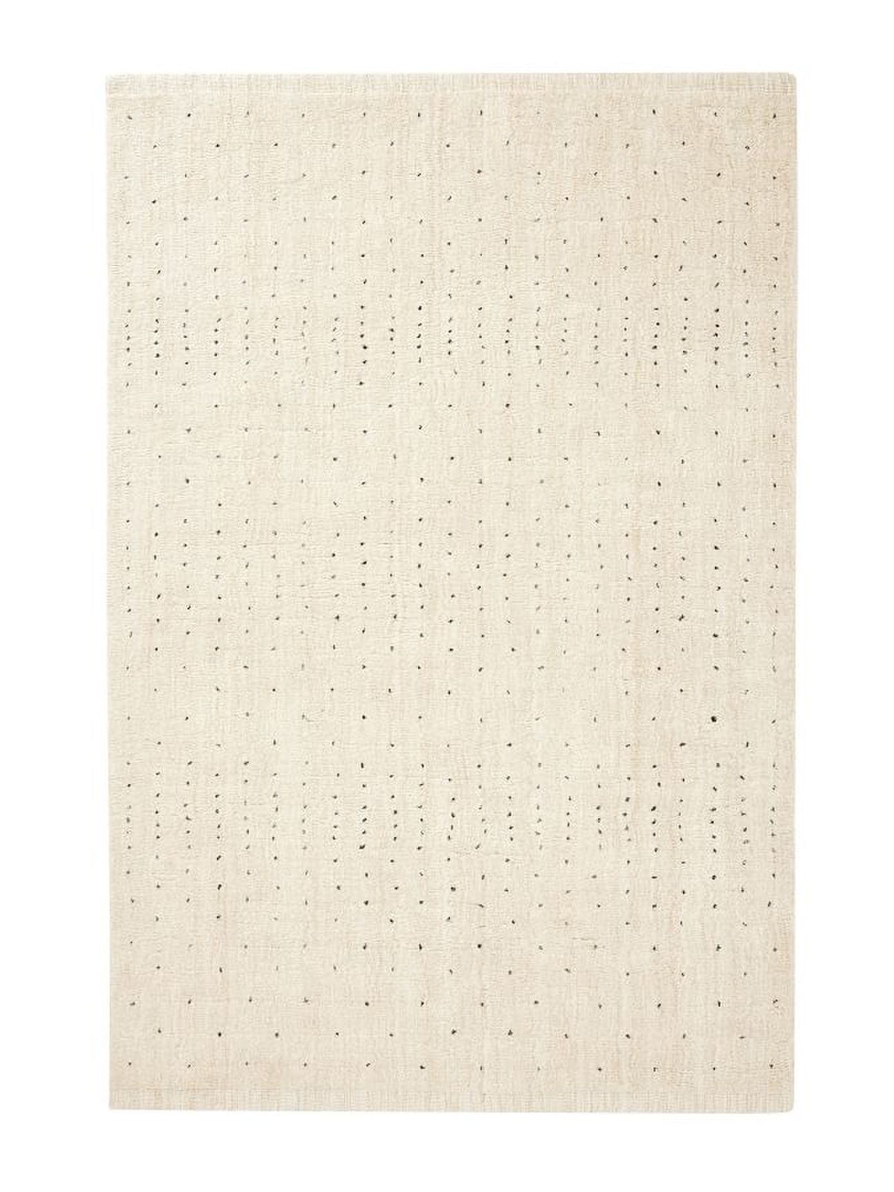 cream-colored pottery barn performance rug with small brown dot accents