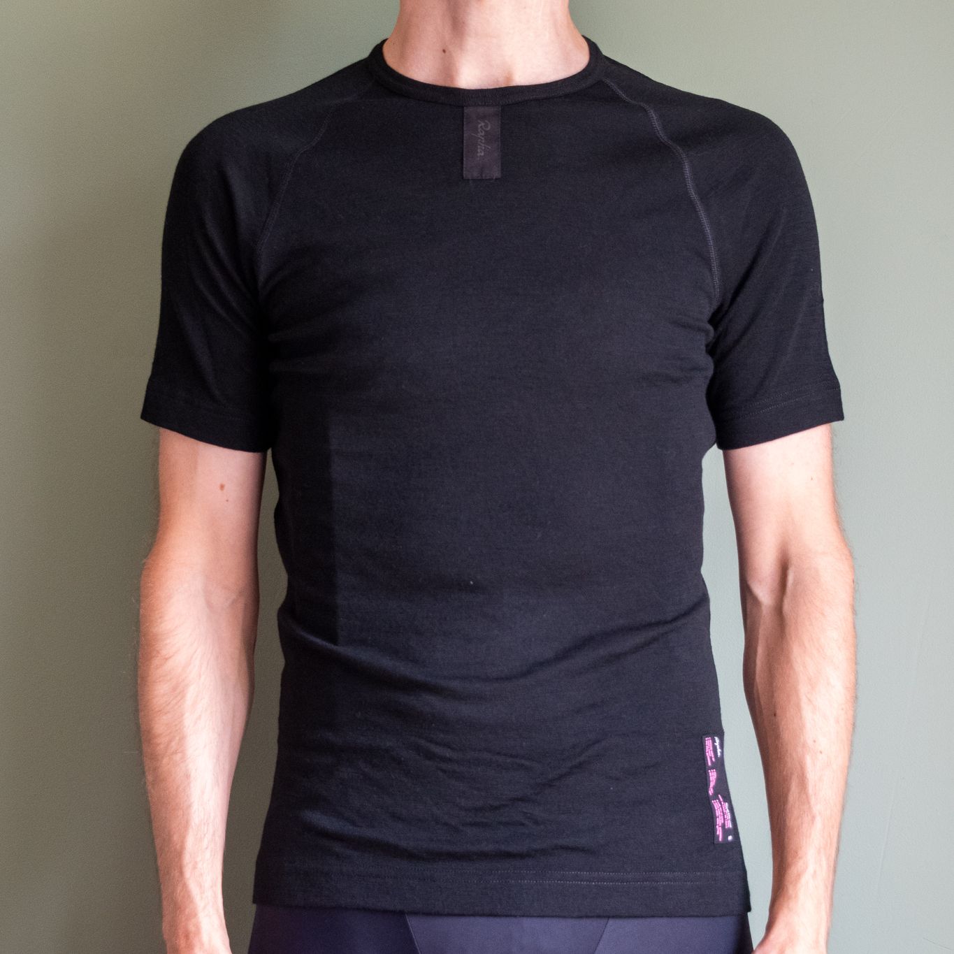 A man wearing a black Rapha merino short-sleeve base layer