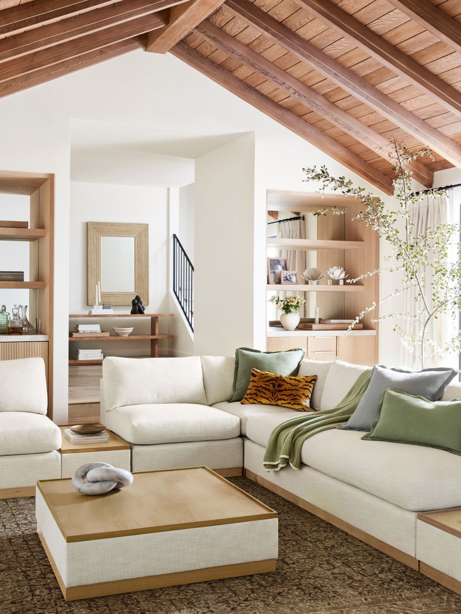 clean lined white sofa in living room with wood beams