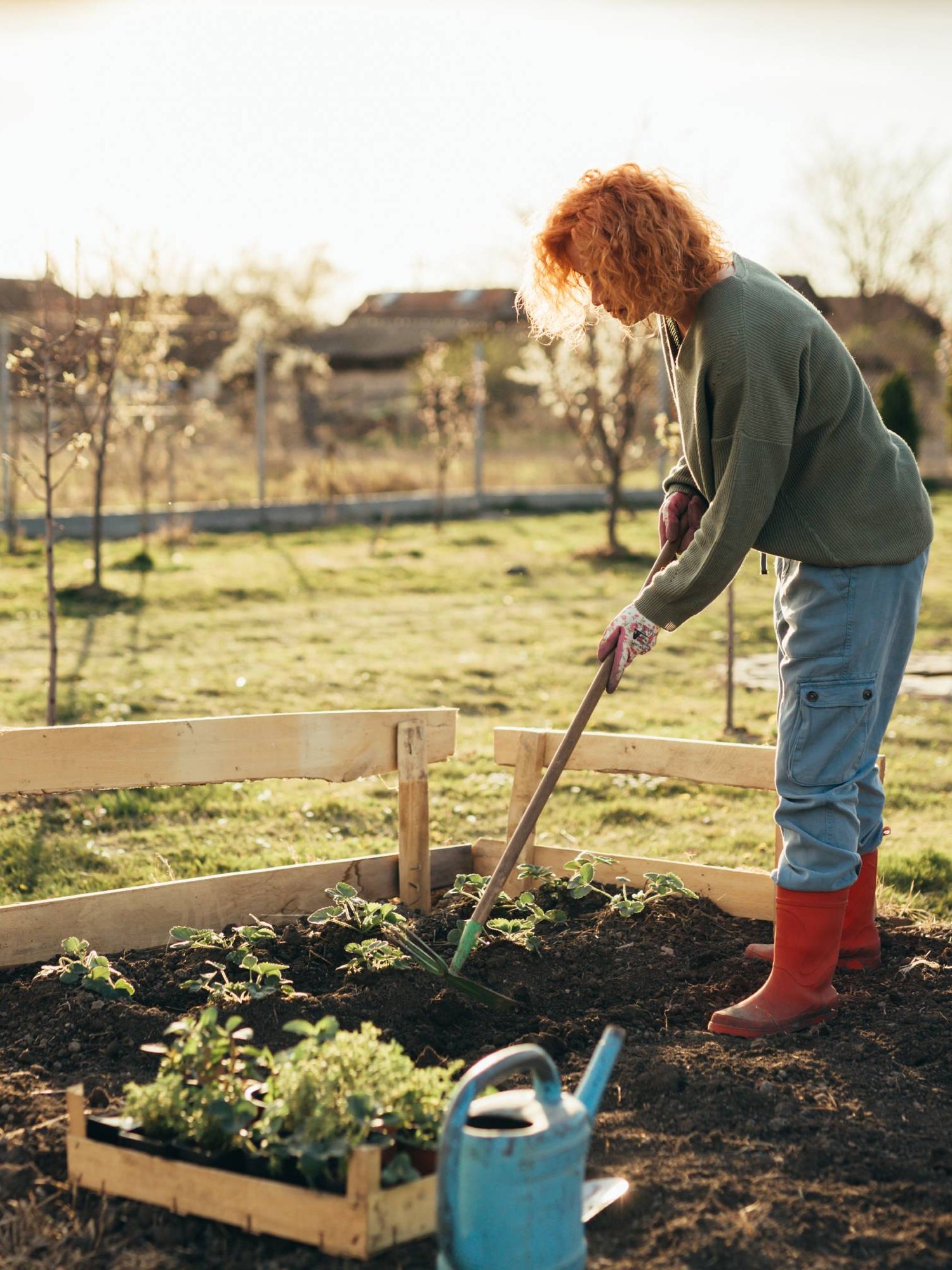 Woman working the soil in garden