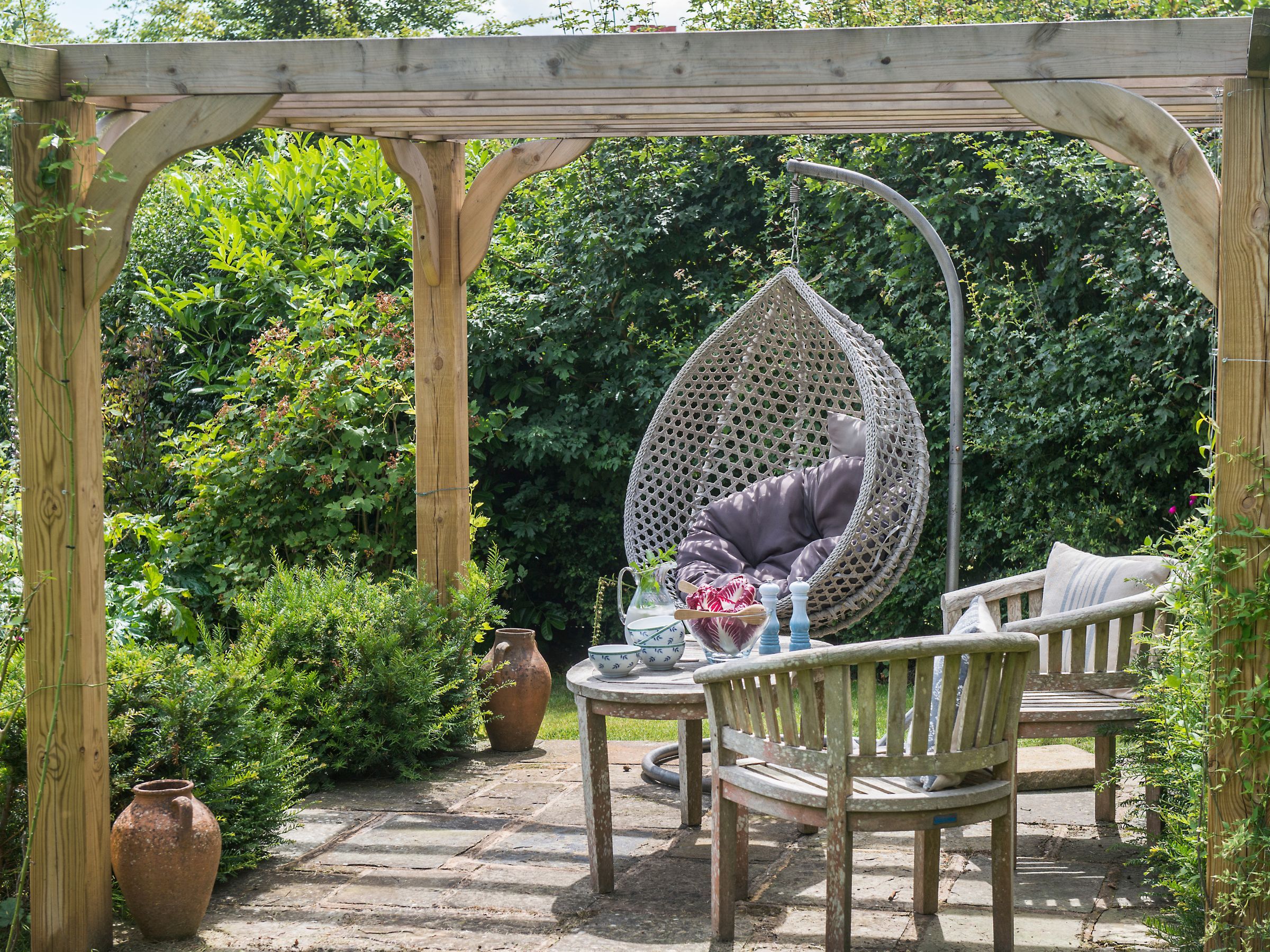 Patio with a pergola and outdoor furniture in a UK garden