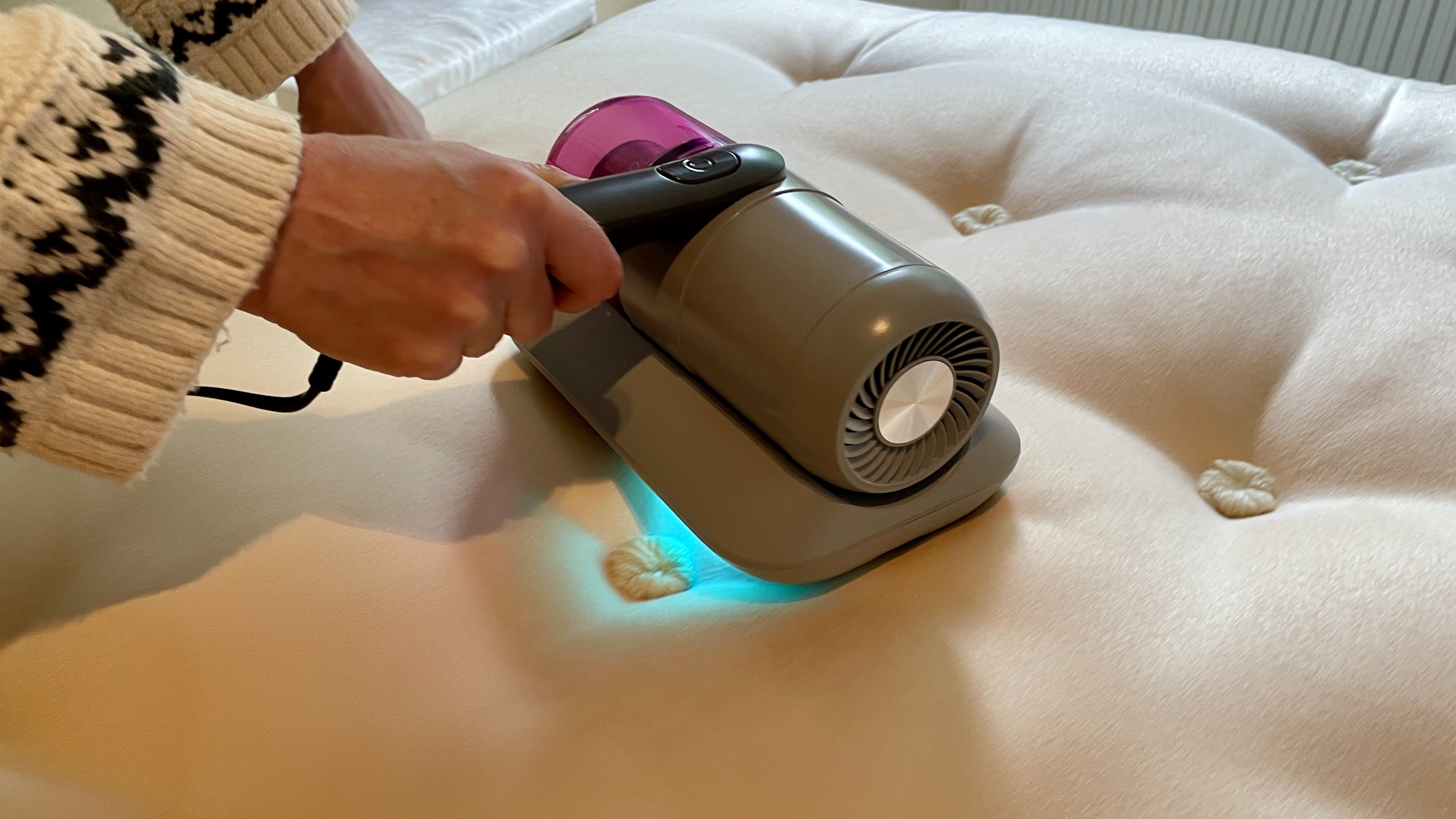 Ambiano Mattress Vacuum on a mattress, showing the UV light